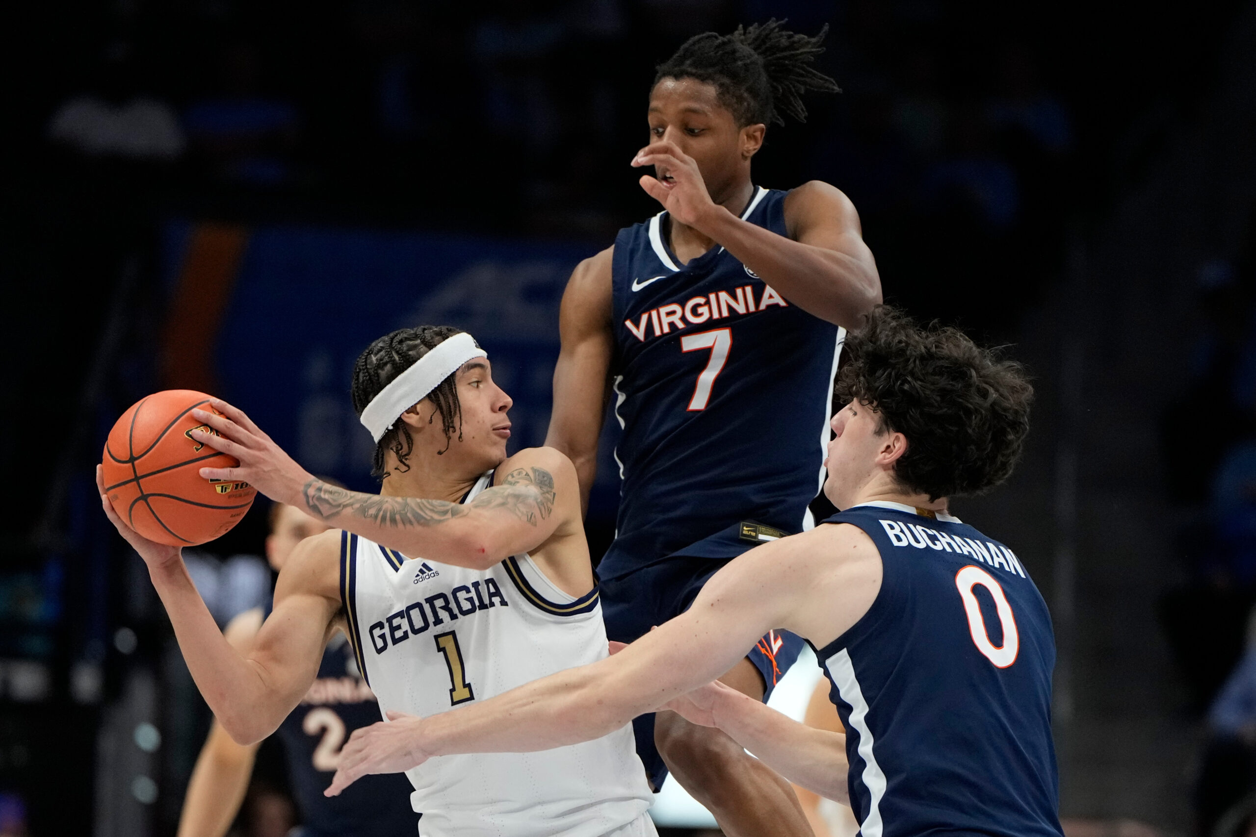 Mar 12, 2025; Charlotte, NC, USA; Georgia Tech Yellow Jackets guard Naithan George (1) with the ball as Virginia Cavaliers guard Dai Dai Ames (7) and forward Blake Buchanan (0) defend in the second half at Spectrum Center. Mandatory Credit: Bob Donnan-Imagn Images