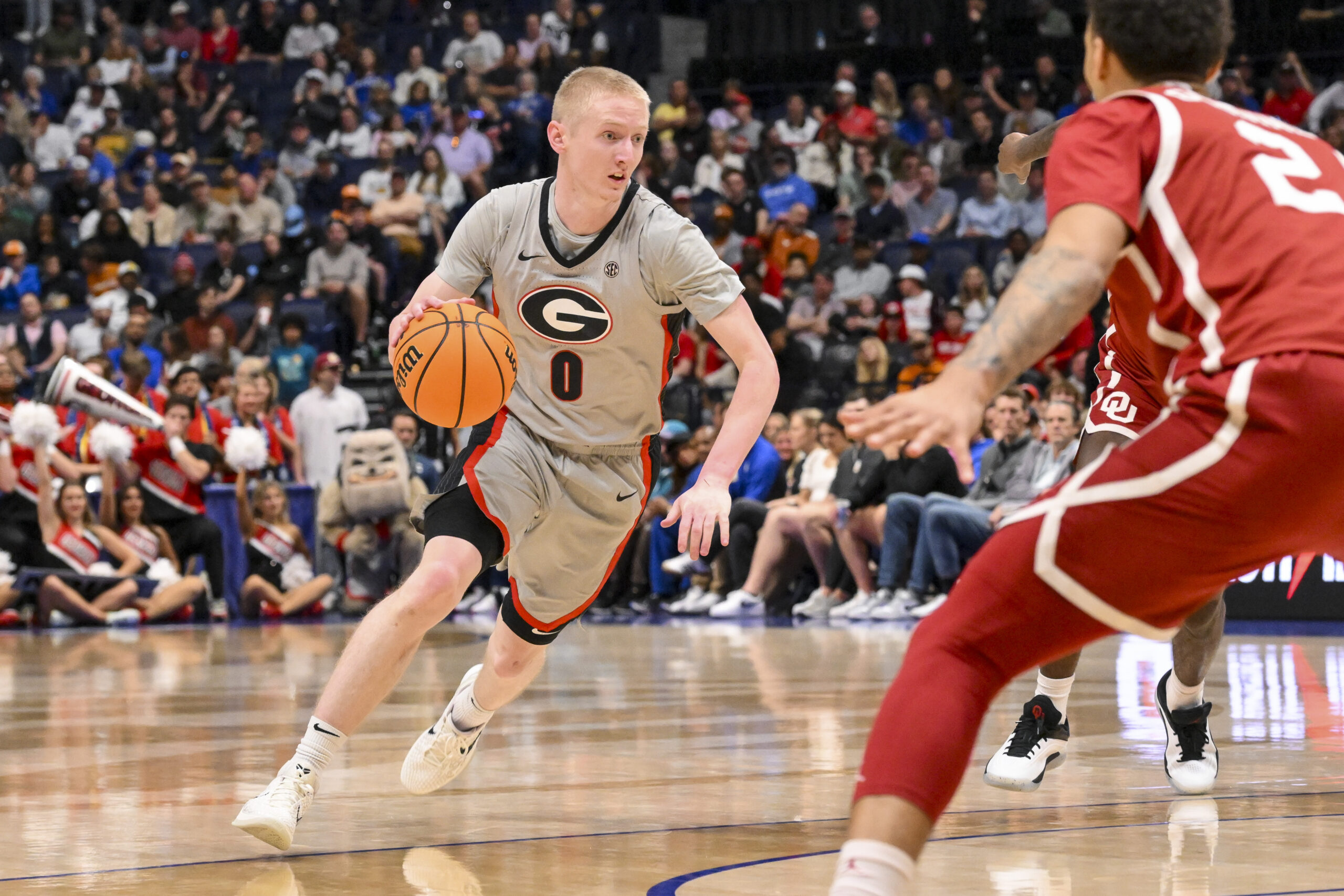 Mar 12, 2025; Nashville, TN, USA; Georgia Bulldogs guard Blue Cain (0) dribbles the ball against the Oklahoma Sooners during the first half at Bridgestone Arena. Mandatory Credit: Steve Roberts-Imagn Images