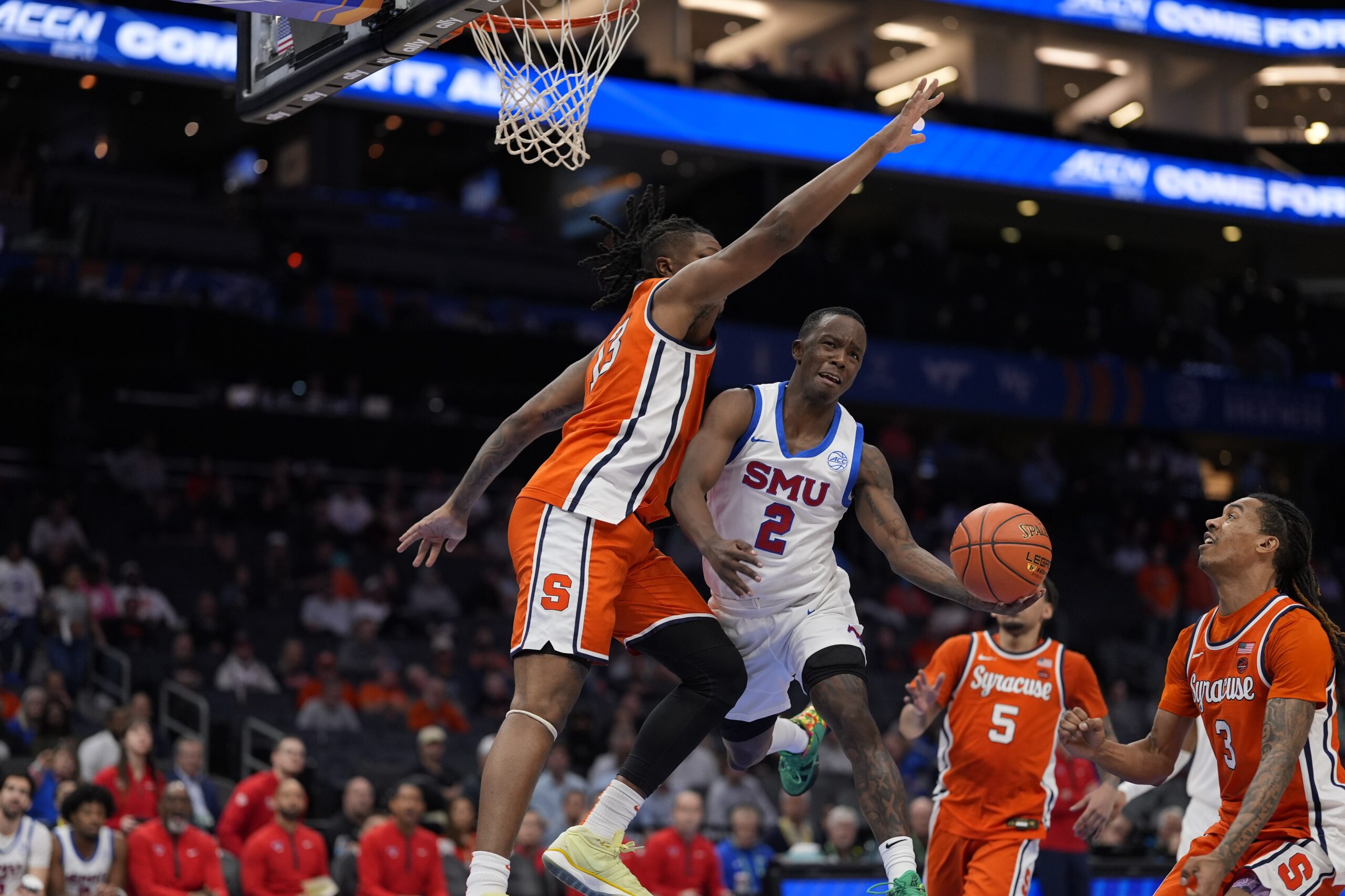 Mar 12, 2025; Charlotte, NC, USA; Southern Methodist Mustangs guard Boopie Miller (2) goes up for a layup against Syracuse Orange forward Jyare Davis (13) during the second half at Spectrum Center. Mandatory Credit: Jim Dedmon-Imagn Images