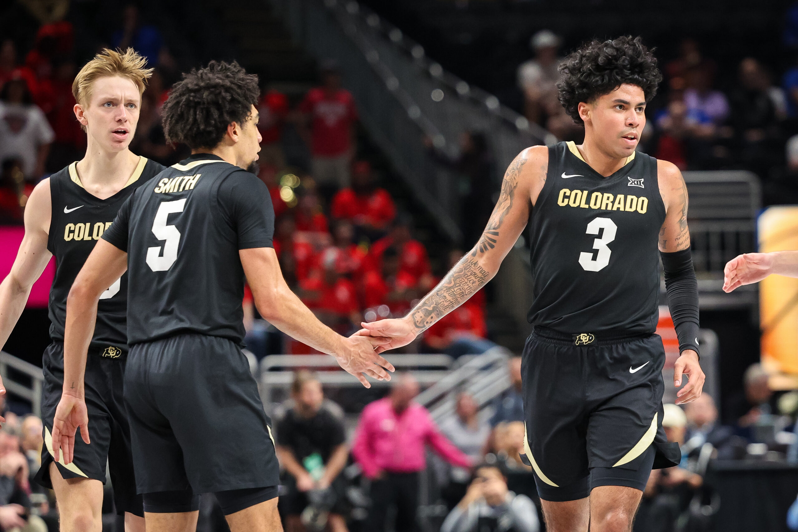 Mar 13, 2025; Kansas City, MO, USA; Colorado Buffaloes guard Julian Hammond III (3) slaps hands with Colorado Buffaloes guard RJ Smith (5) after a play during the first half against the Houston Cougars at T-Mobile Center. Mandatory Credit: William Purnell-Imagn Images