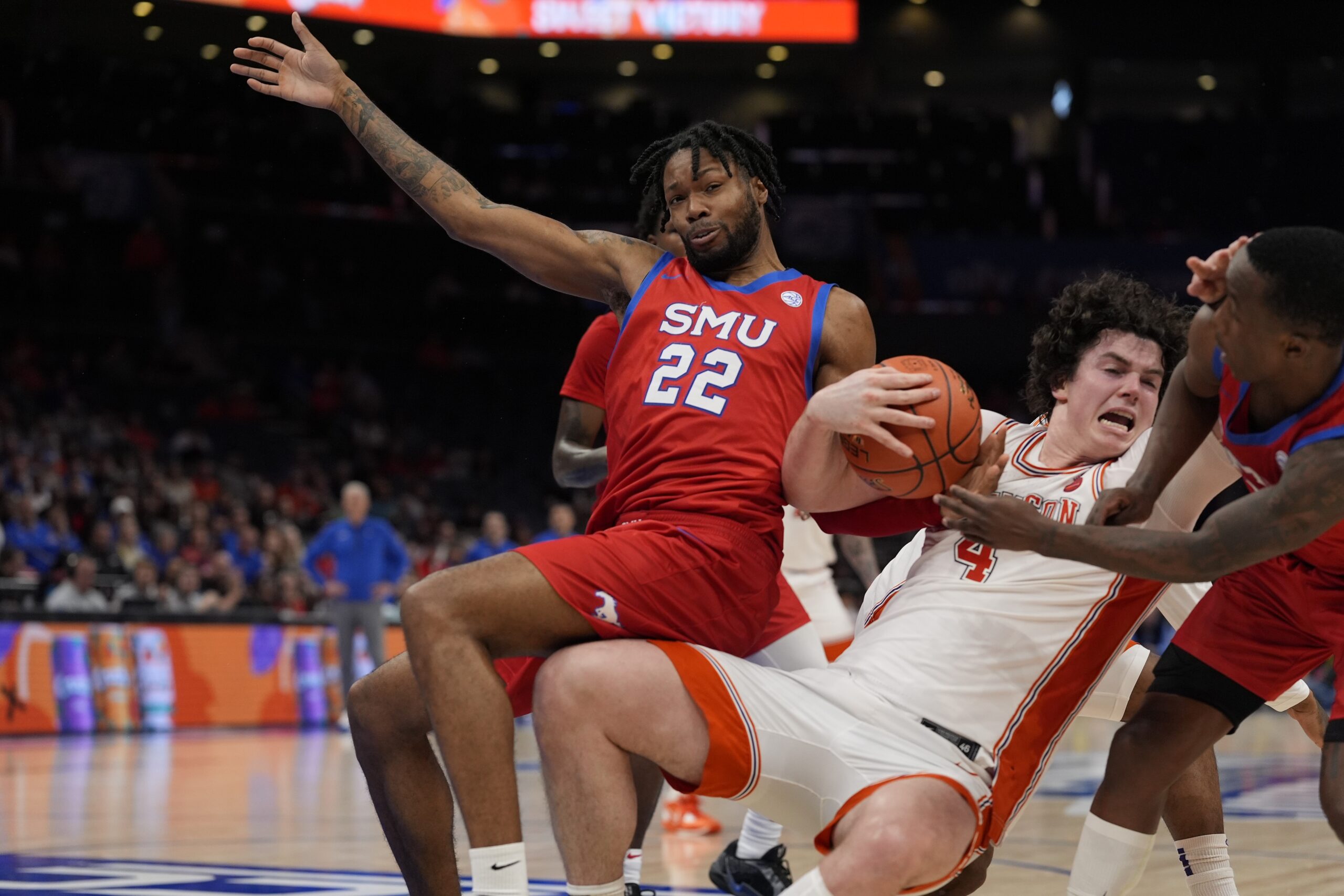 Mar 13, 2025; Charlotte, NC, USA; Clemson Tigers forward Ian Schieffelin (4) holds onto the rebound against Southern Methodist Mustangs forward Keon Ambrose-Hylton (22) and guard Chuck Harris (3) during the second half at Spectrum Center. Mandatory Credit: Jim Dedmon-Imagn Images