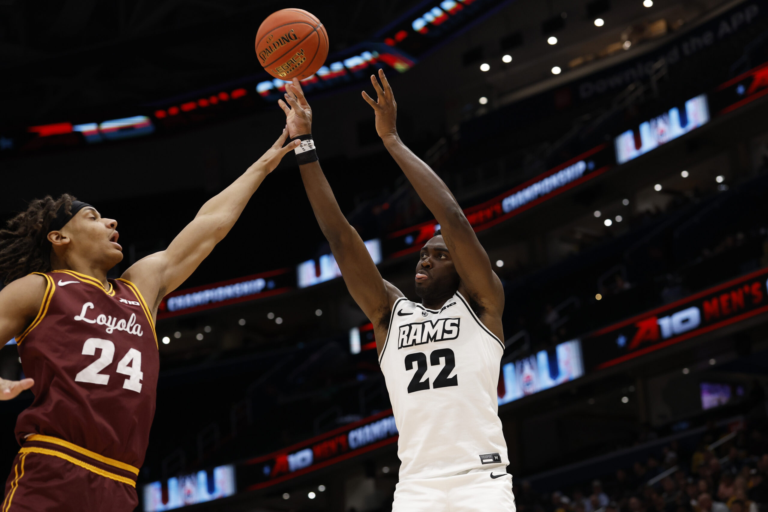 Mar 15, 2025; Washington, D.C., USA; VCU Rams guard Joe Bamisile (22) shoots the ball over Loyola Chicago Ramblers center Miles Rubin (24) in the second half at Capital One Arena. Mandatory Credit: Geoff Burke-Imagn Images