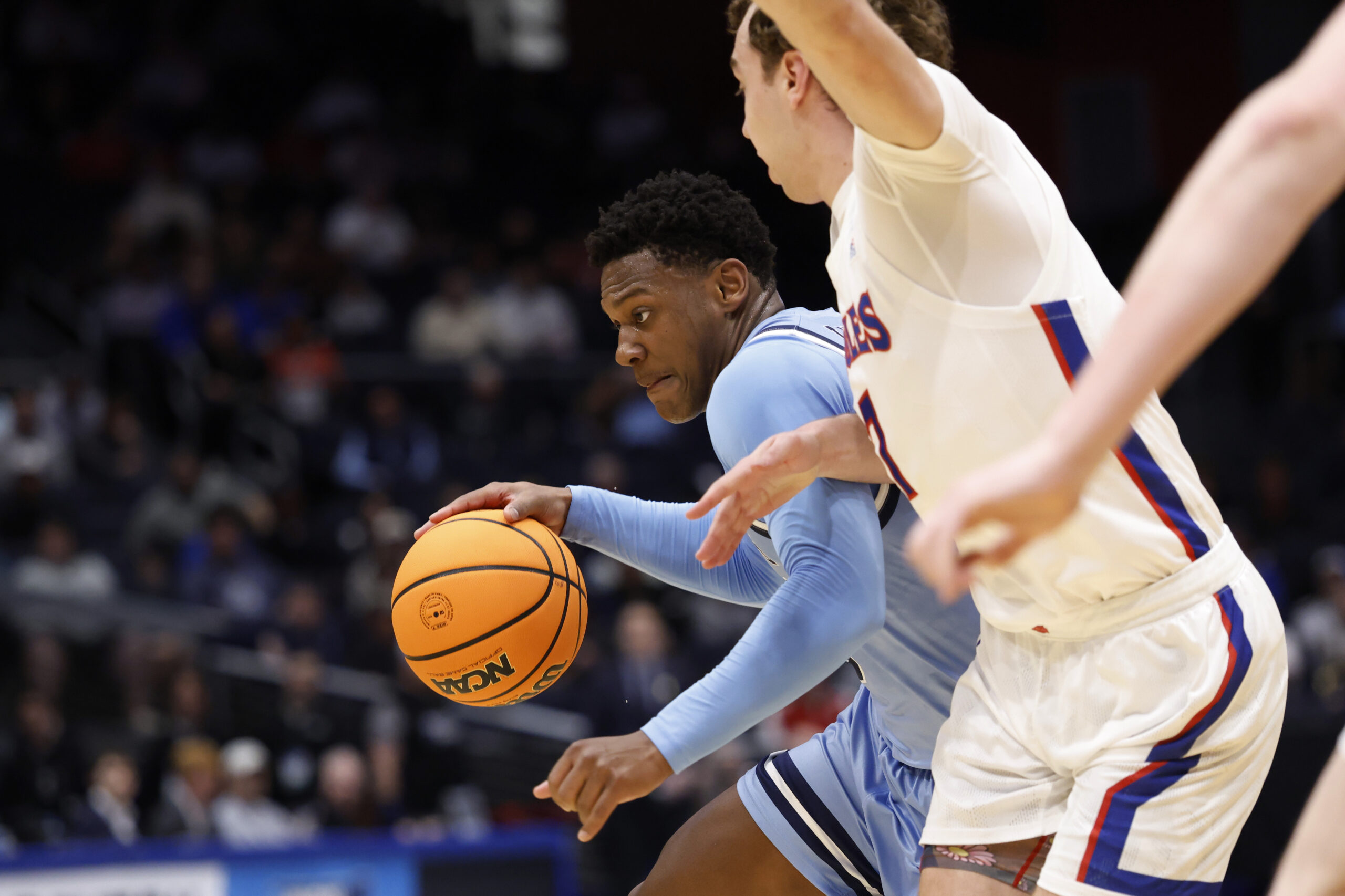 Mar 19, 2025; Dayton, OH, USA; Mount St. Mary's Mountaineers guard Xavier Lipscomb (45) plays the ball defended by American University Eagles guard Wyatt Nausadis (7) in the first half at UD Arena. Mandatory Credit: Rick Osentoski-Imagn Images
