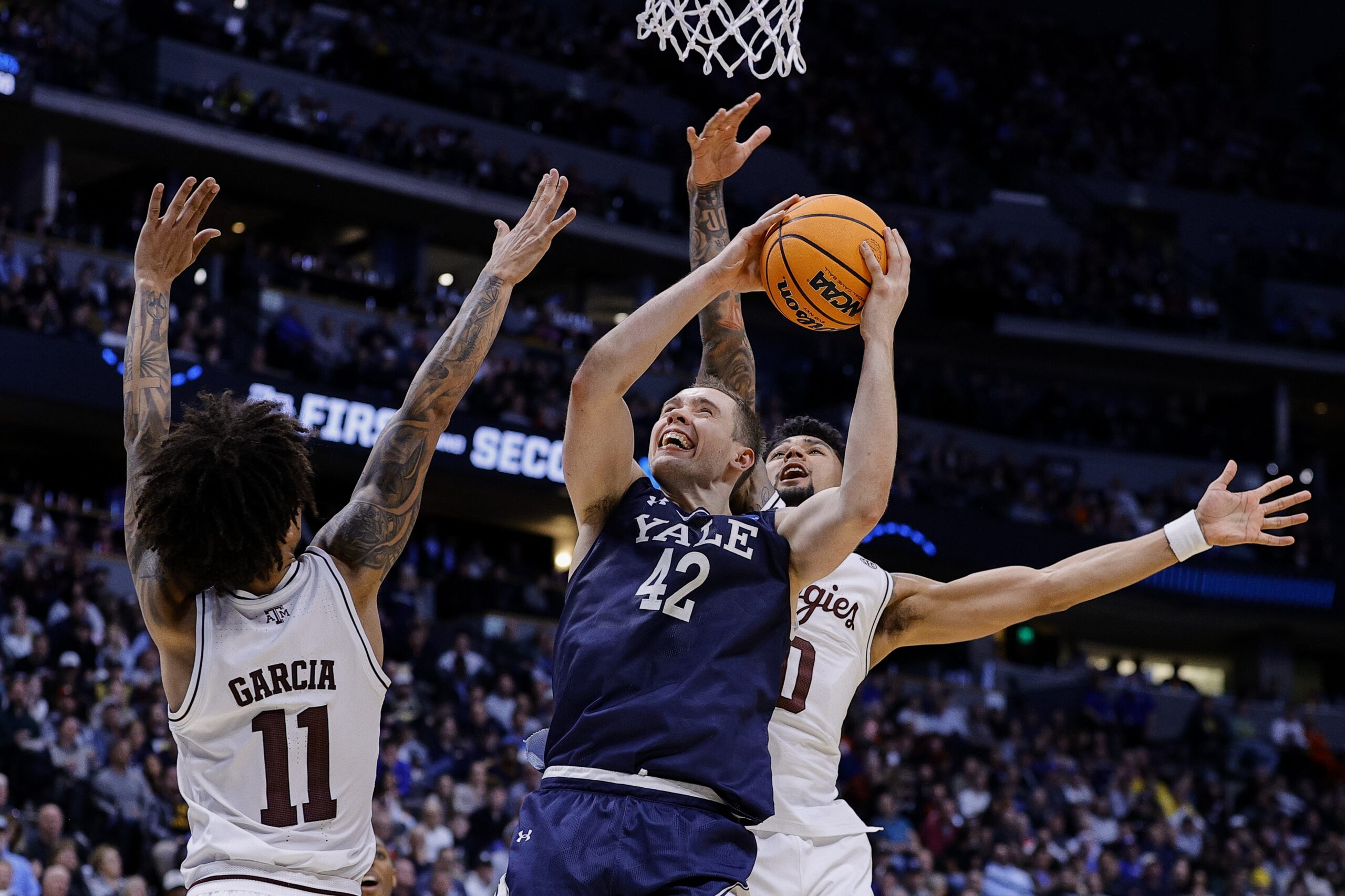 March 20, 2025; Denver, CO, USA; Yale Bulldogs forward Nick Townsend (42) attempts to shoot the ball against the Texas A&M Aggies at Ball Arena. Mandatory Credit: Isaiah J. Downing-Imagn Images