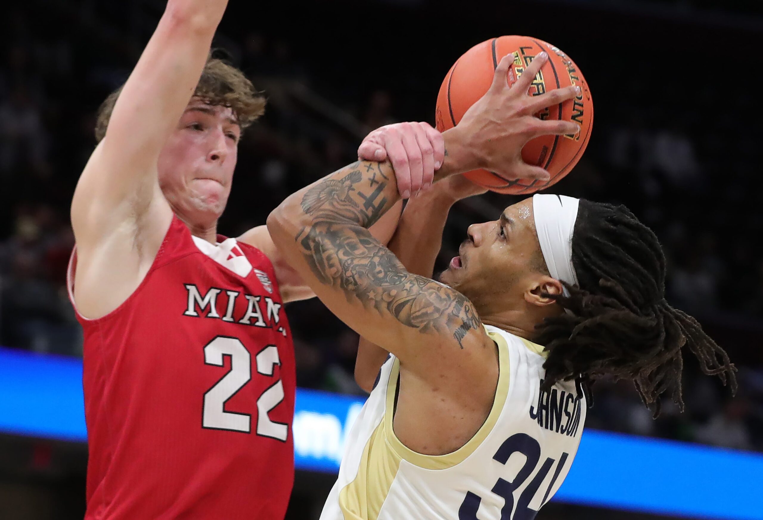 Akron Zips guard Nate Johnson (34) is fouled by Miami RedHawks forward Brant Byers (22) during the Mid-American Conference Tournament championship game March 15, 2025, in Cleveland, Ohio.