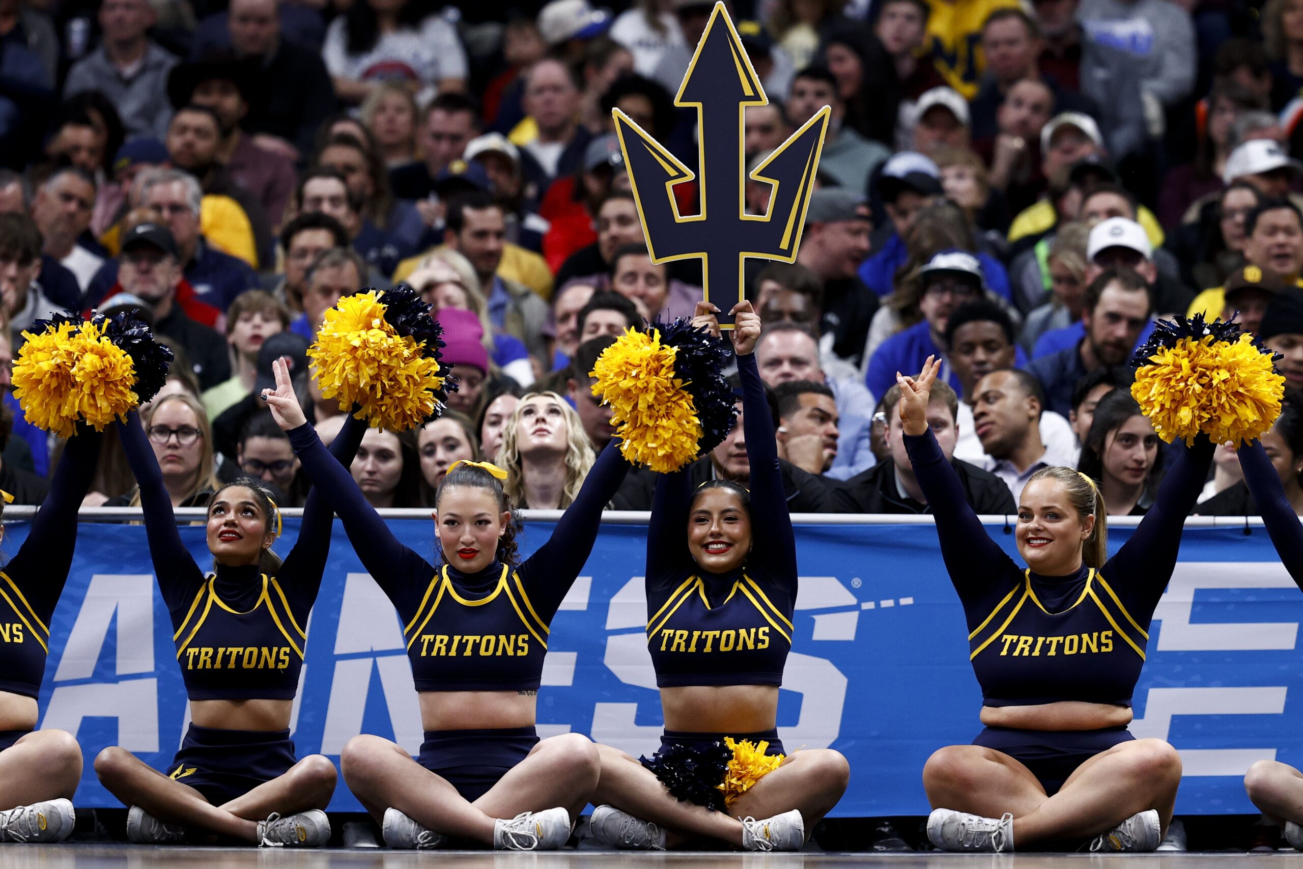 March 20, 2025; Denver, CO, USA; UC San Diego Tritons cheerleaders on the baseline during the first half against the Michigan Wolverines at Ball Arena. Mandatory Credit: Isaiah J. Downing-Imagn Images