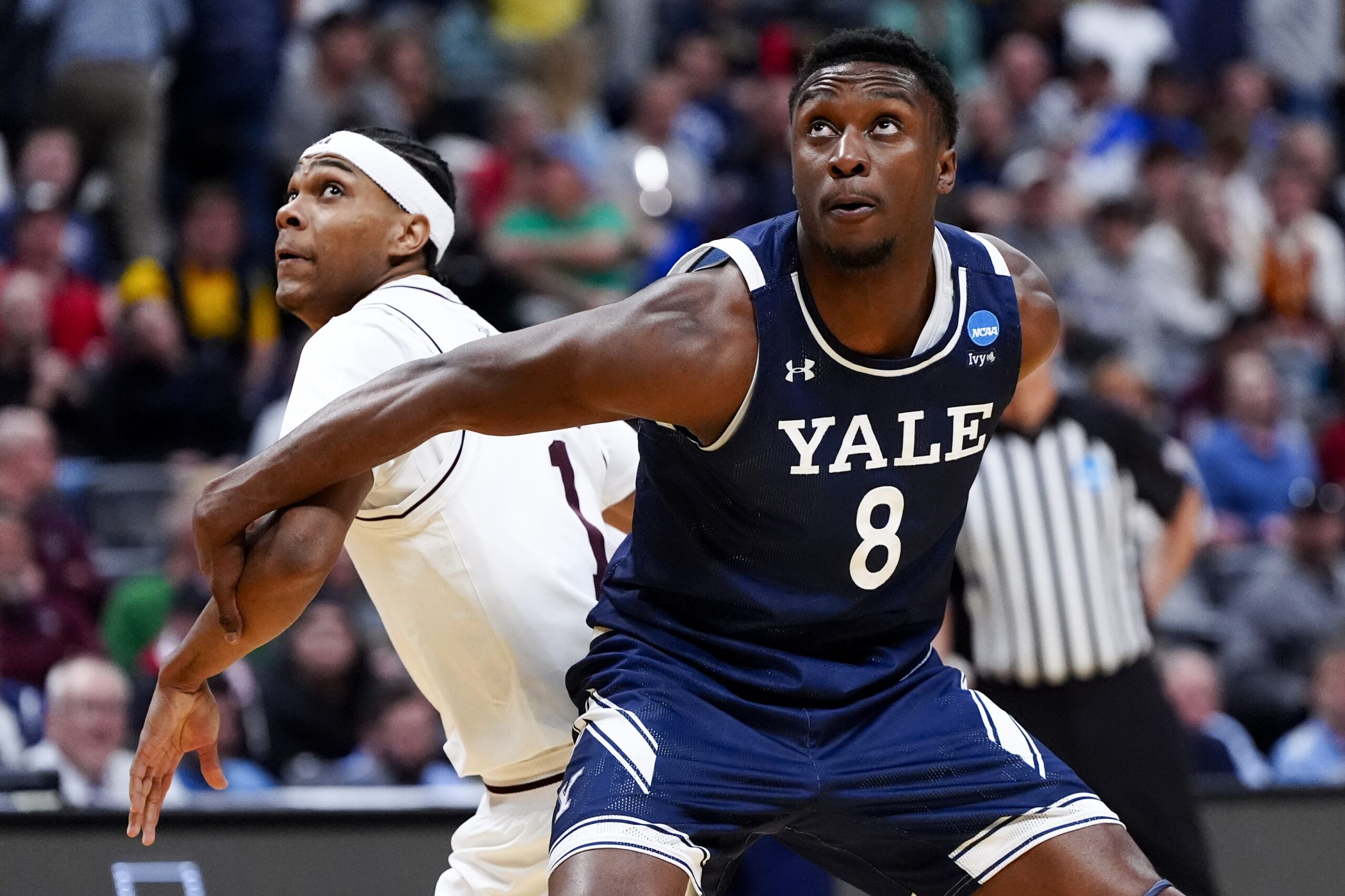 March 20, 2025; Denver, CO, USA; Yale Bulldogs forward Isaac Celiscar (8) boxes out Texas A&M Aggies guard Zhuric Phelps (1) during the second half at Ball Arena. Mandatory Credit: Ron Chenoy-Imagn Images