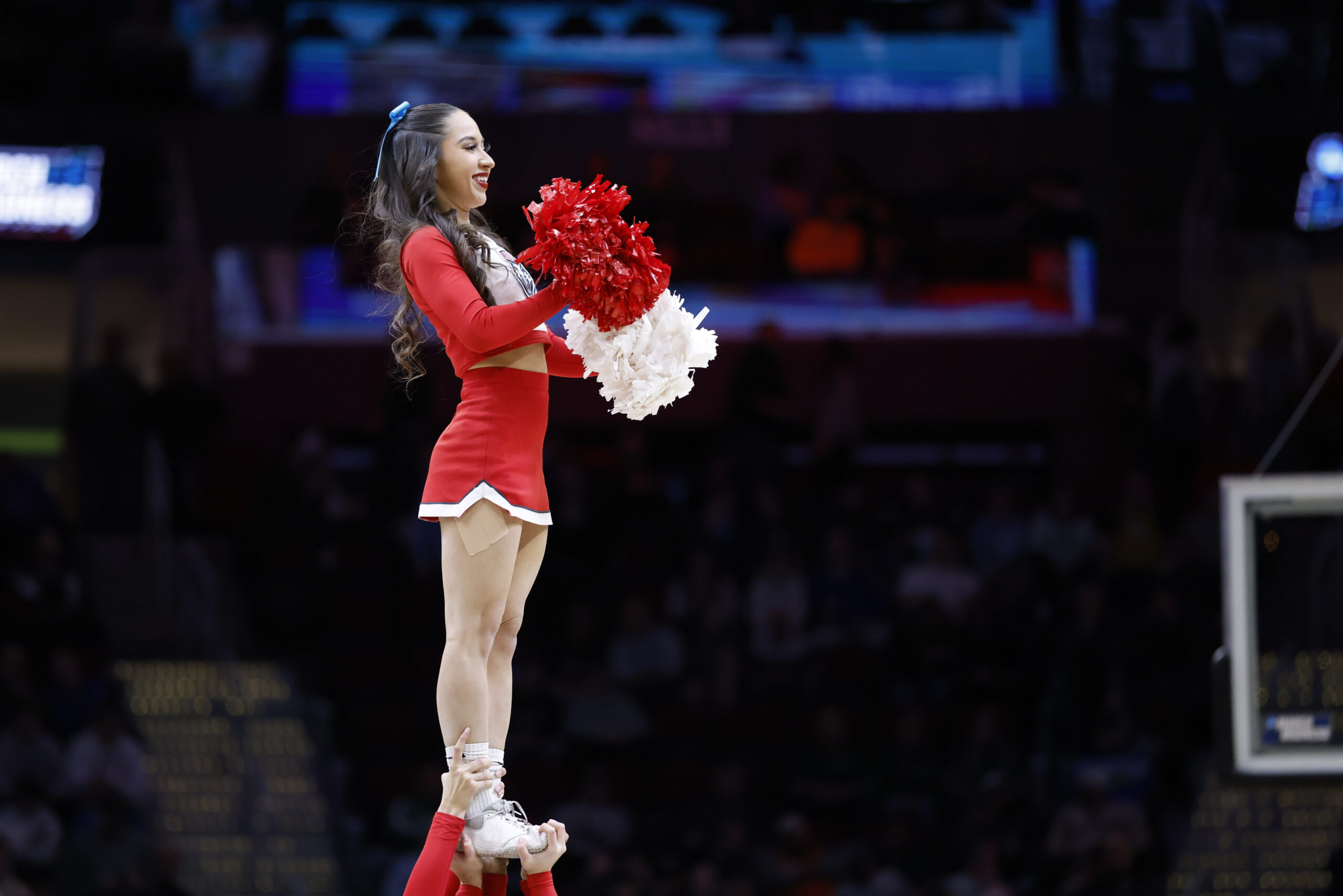 Mar 21, 2025; Cleveland, OH, USA; New Mexico Lobos cheerleader performs in the first half against the Marquette Golden Eagles during the NCAA Tournament First Round at Rocket Arena. Mandatory Credit: Rick Osentoski-Imagn Images