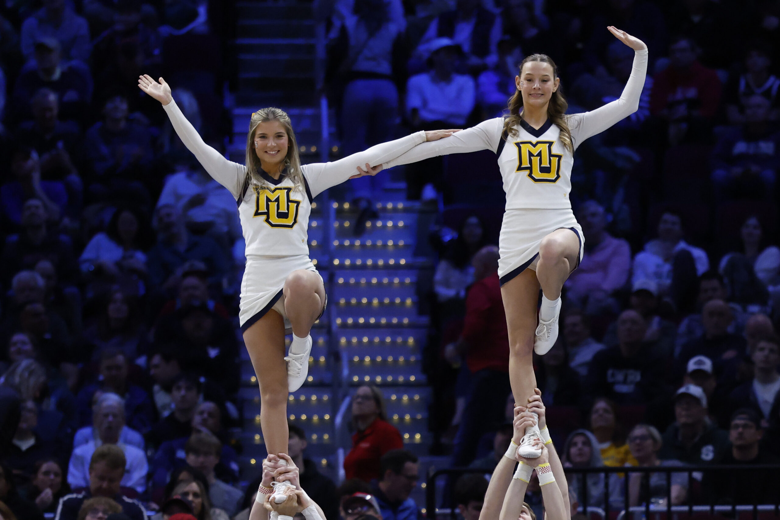 Mar 21, 2025; Cleveland, OH, USA; Marquette Golden Eagles cheerleaders perform in the first half against the New Mexico Lobos during the NCAA Tournament First Round at Rocket Arena. Mandatory Credit: Rick Osentoski-Imagn Images
