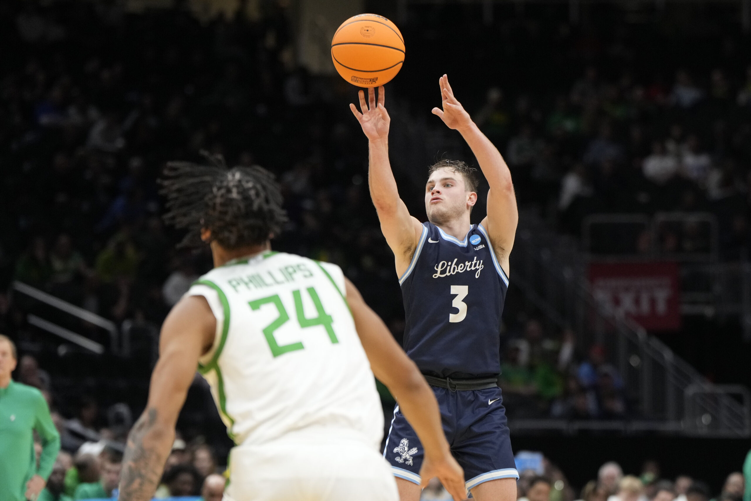 Mar 21, 2025; Seattle, WA, USA; Liberty Flames guard Kaden Metheny (3) shoots the ball against Oregon Ducks guard Jamari Phillips (24) during the second half in the first round of the NCAA Tournament at Climate Pledge Arena. Mandatory Credit: Stephen Brashear-Imagn Images