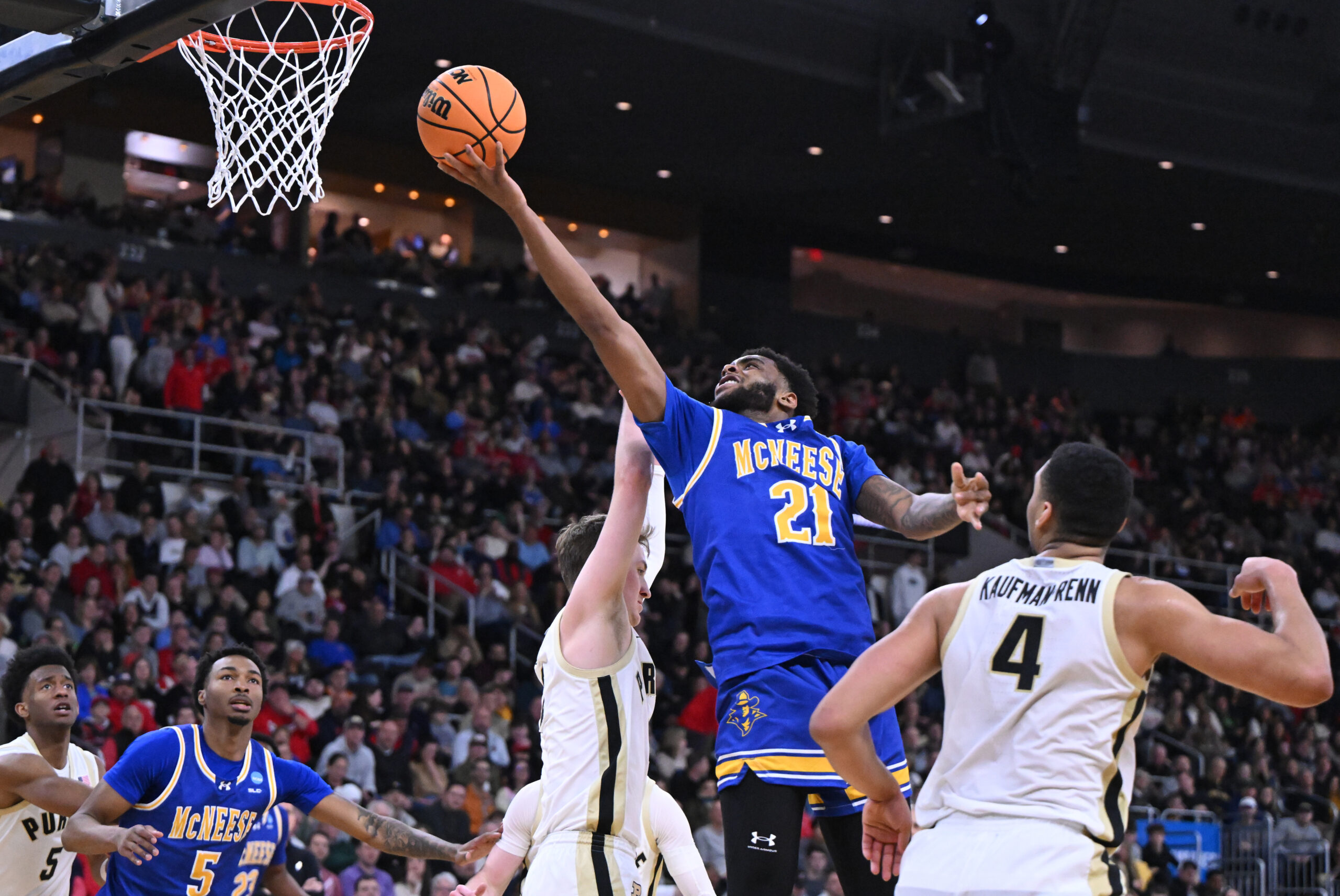 Mar 22, 2025; Providence, RI, USA; McNeese State Cowboys guard Sincere Parker (21) shoots against Purdue Boilermakers guard Fletcher Loyer (2) and forward Trey Kaufman-Renn (4) during the second half of a second round men’s NCAA Tournament game at Amica Mutual Pavilion. Mandatory Credit: Brian Fluharty-Imagn Images