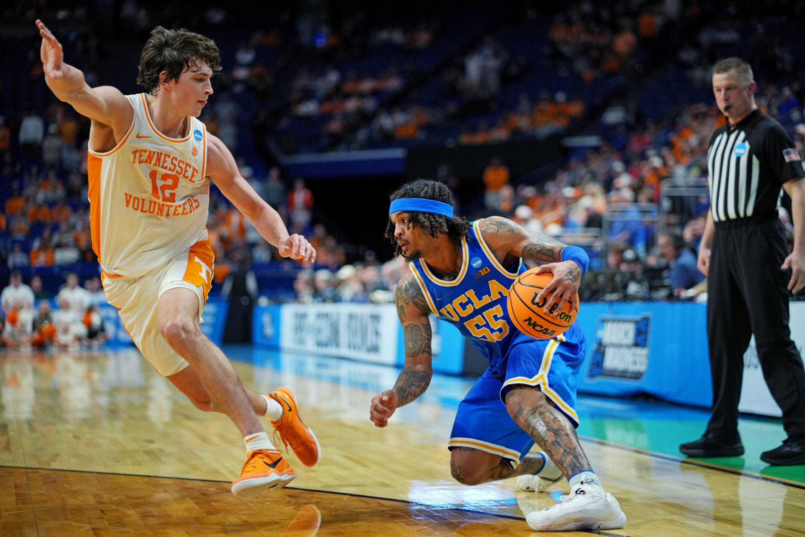 Mar 22, 2025; Lexington, KY, USA; UCLA Bruins guard Skyy Clark (55) handles the ball against Tennessee Volunteers forward Cade Phillips (12) during the second half in the second round of the NCAA Tournament at Rupp Arena. Mandatory Credit: Aaron Doster-Imagn Images