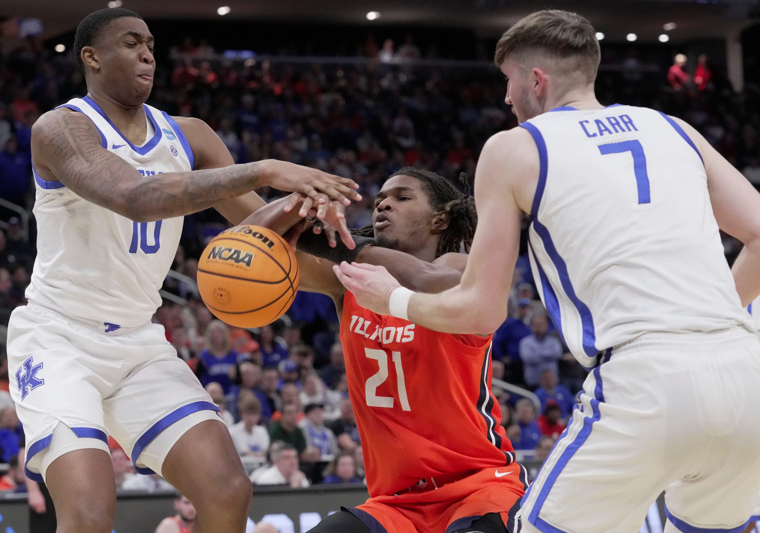 Illinois forward Morez Johnson Jr. (21) is foule day Kentucky forward Andrew Carr (7) and forward Brandon Garrison (10) also defends during the second half of their second round NCAA men’ s basketball tournament game Sunday, March 23, 2025 at Fiserv Forum in Milwaukee, Wisconsin. Kentucky beat Illinois 84-75.