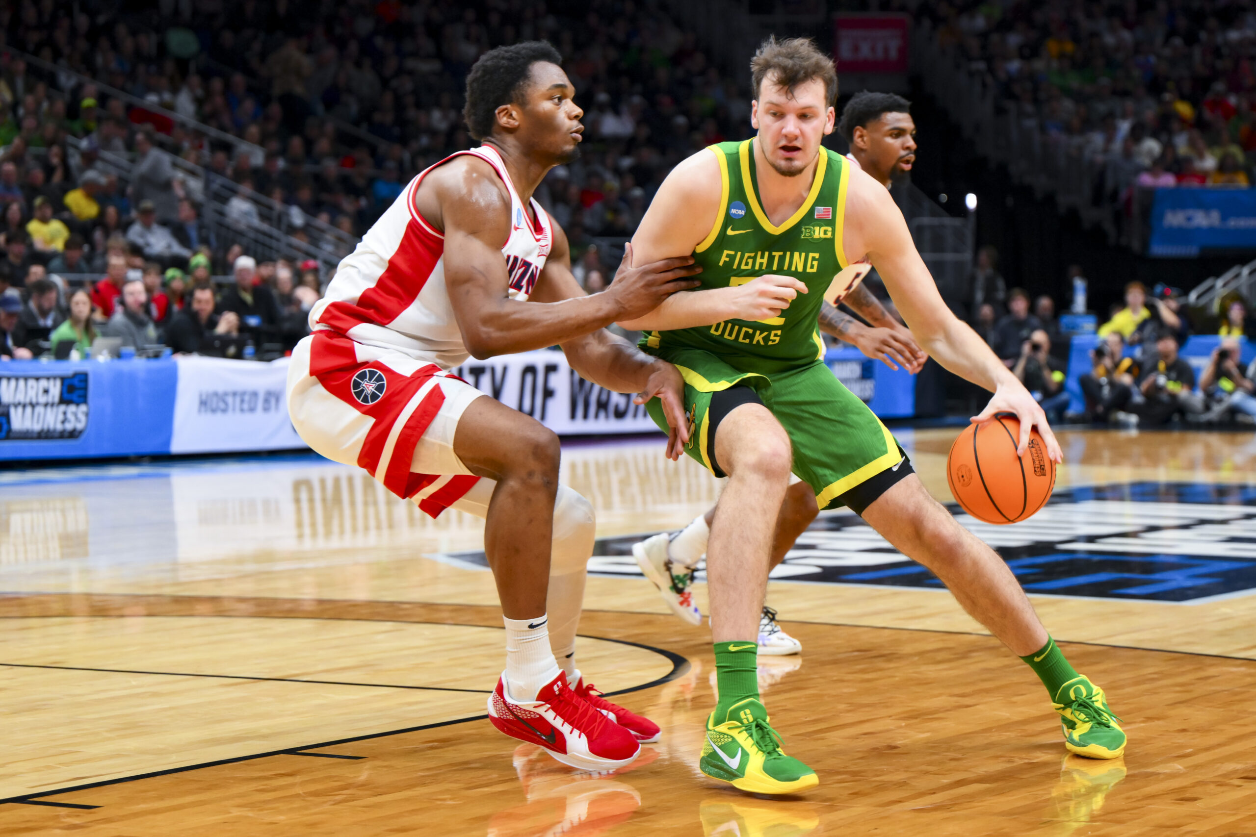 Mar 23, 2025; Seattle, WA, USA; Oregon Ducks center Nate Bittle (32) dribbles the ball against Arizona Wildcats forward Tobe Awaka (30) in the first half at Climate Pledge Arena. Mandatory Credit: Steven Bisig-Imagn Images
