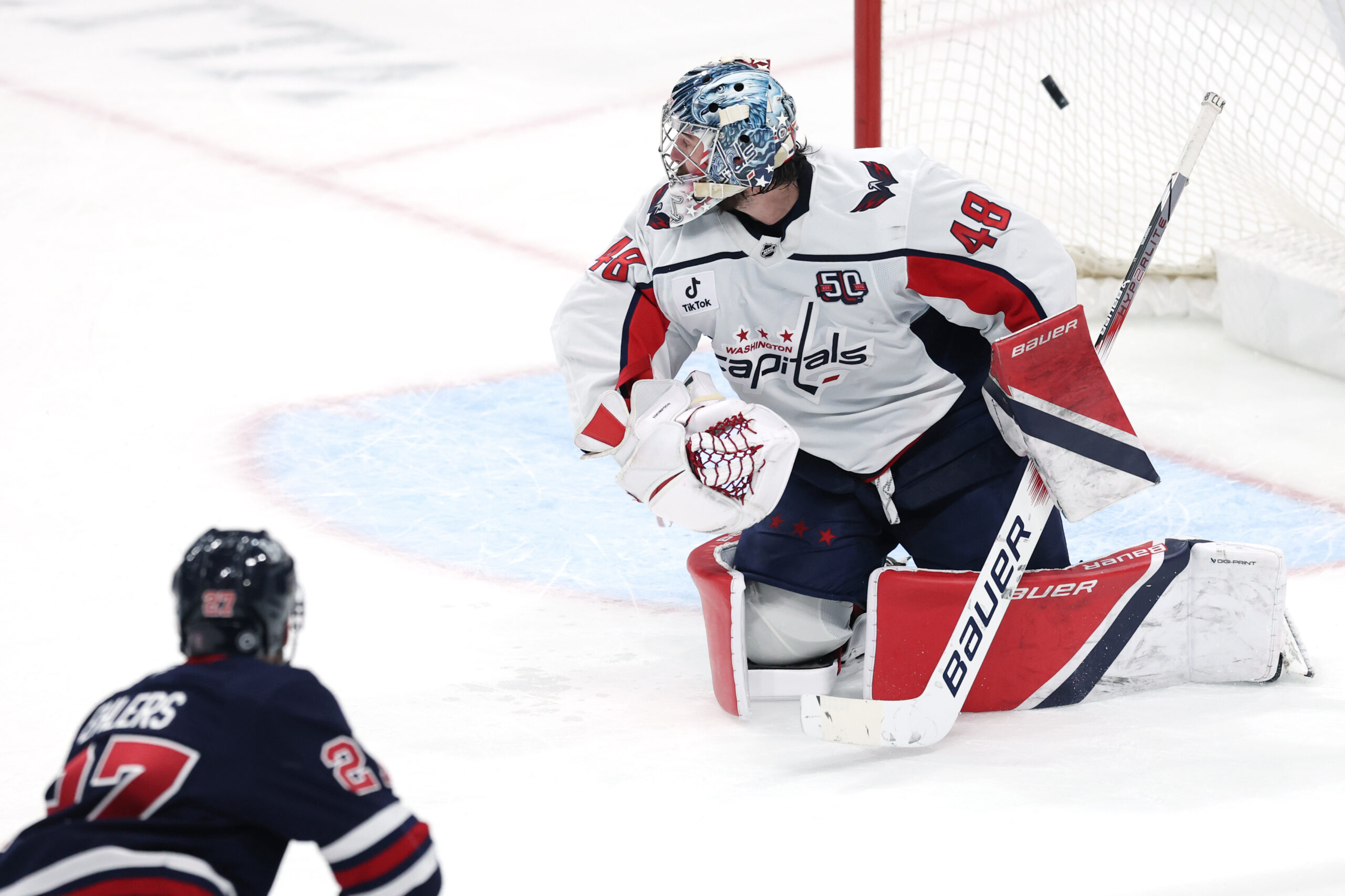 Mar 25, 2025; Winnipeg, Manitoba, CAN; Winnipeg Jets left wing Nikolaj Ehlers (27) scores on Washington Capitals goaltender Logan Thompson (48) in overtime at Canada Life Centre. Mandatory Credit: James Carey Lauder-Imagn Images