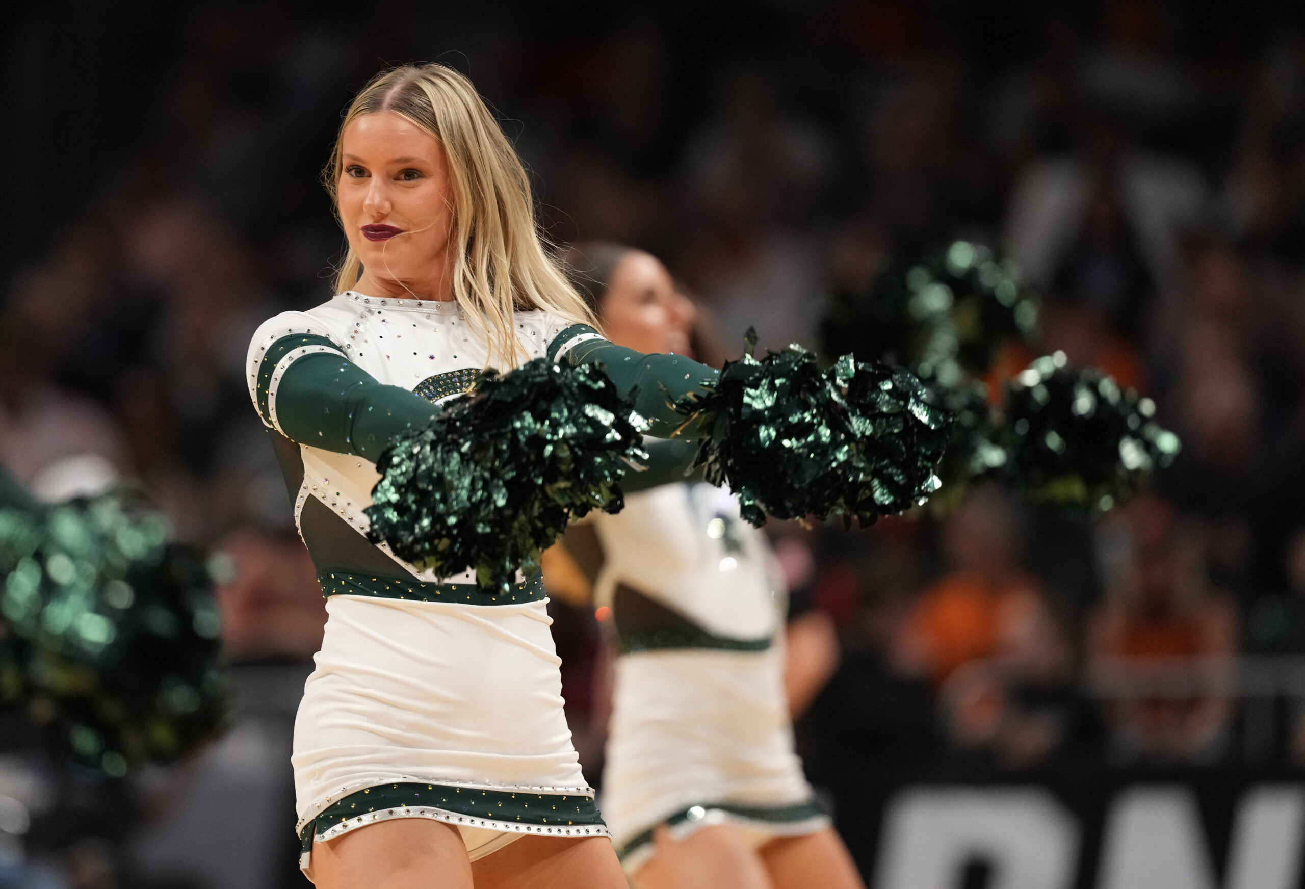 Mar 28, 2025; Atlanta, GA, USA; Michigan State Spartans cheerleaders in the second half of a South Regional semifinal of the 2025 NCAA tournament against the Mississippi Rebels at State Farm Arena. Mandatory Credit: Dale Zanine-Imagn Images