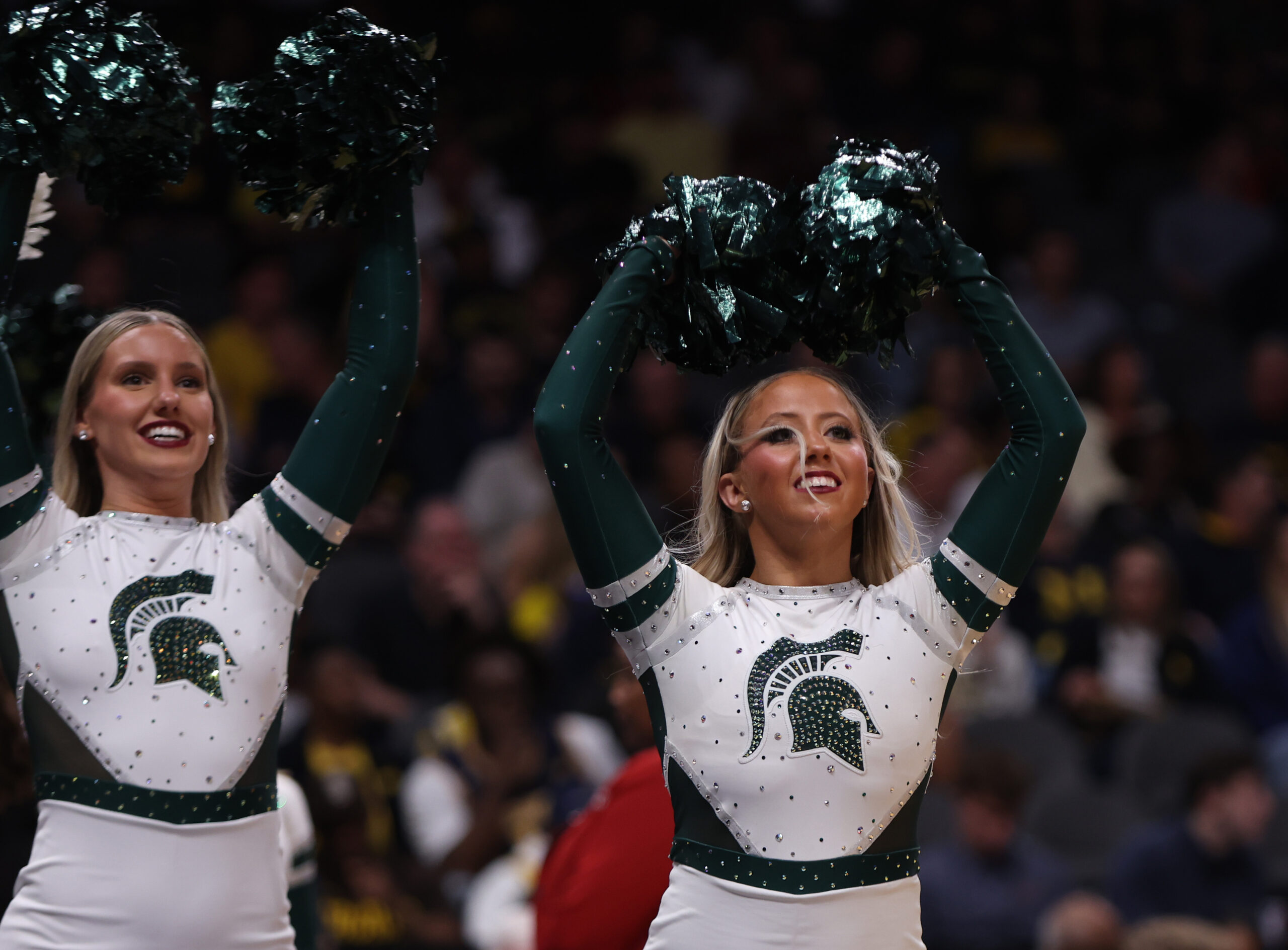 Mar 28, 2025; Atlanta, GA, USA; Michigan State Spartans cheerleaders celebrate after defeating the Mississippi Rebels in a South Regional semifinal of the 2025 NCAA tournament at State Farm Arena. Mandatory Credit: Brett Davis-Imagn Images