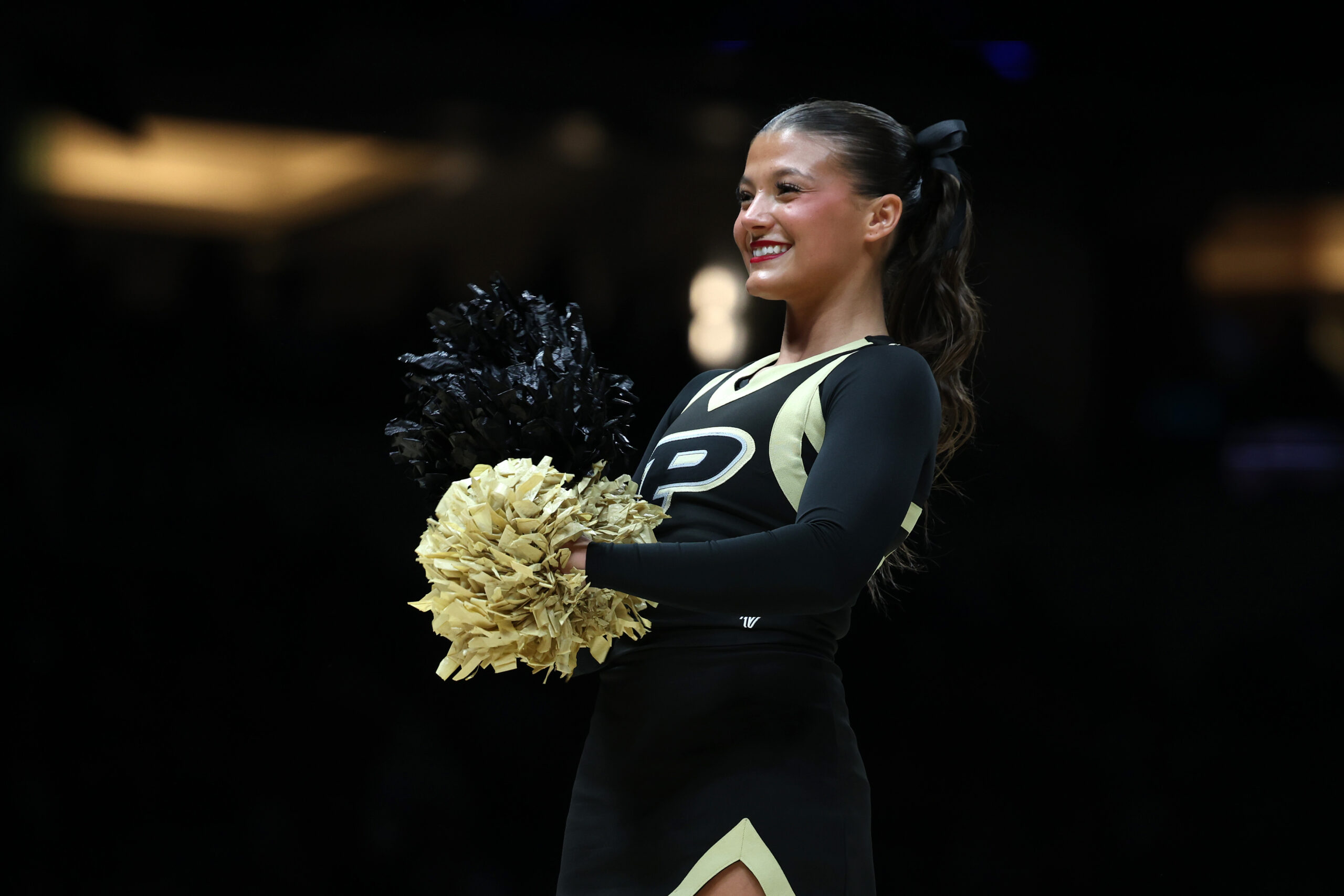 Mar 28, 2025; Indianapolis, IN, USA; The Purdue Boilermakers cheerleaders perform in the first half during a Midwest Regional semifinal of the 2025 NCAA tournament at Lucas Oil Stadium. Mandatory Credit: Trevor Ruszkowski-Imagn Images