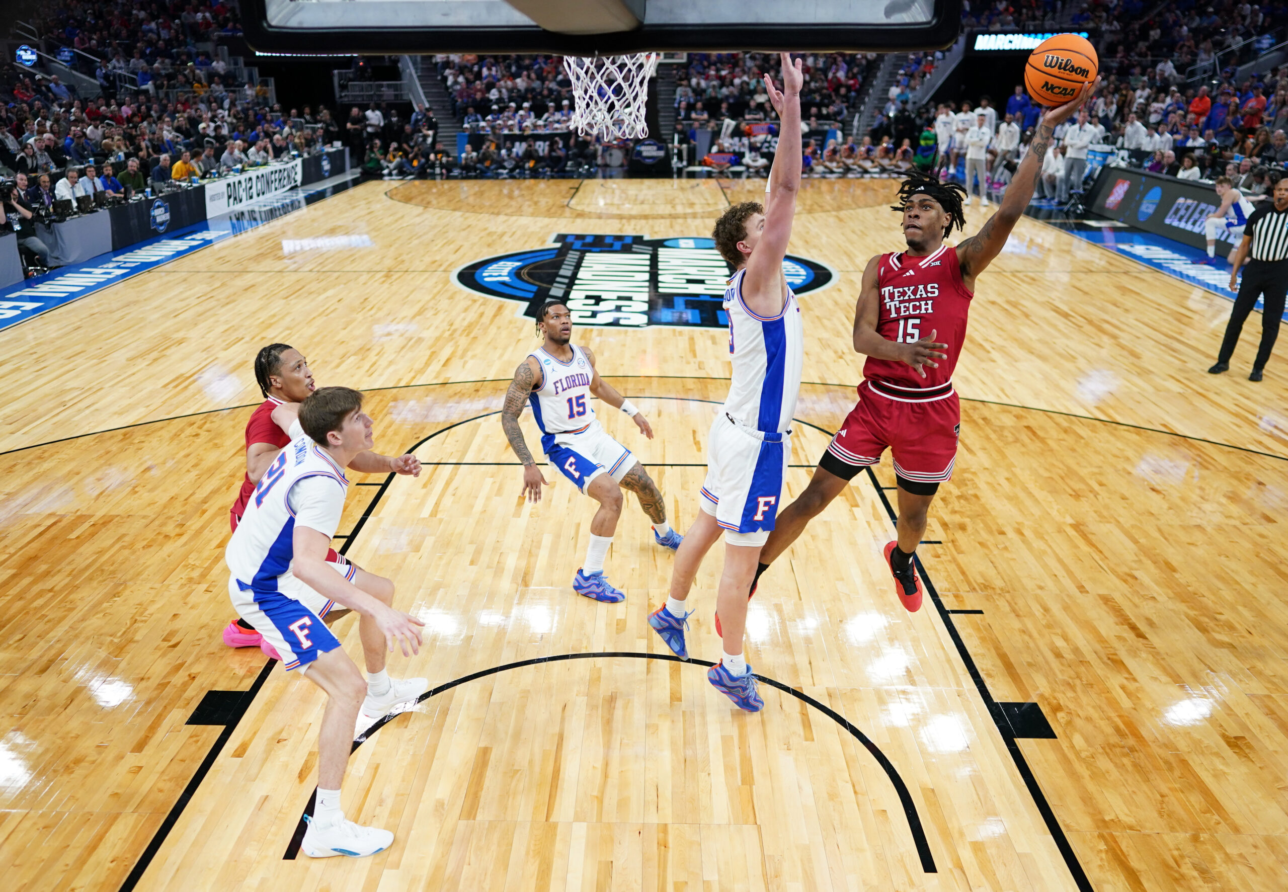 Mar 29, 2025; San Francisco, CA, USA; Texas Tech Red Raiders forward JT Toppin (15) drives to the hoop past Florida Gators center Micah Handlogten (3) during the second half during the West Regional final of the 2025 NCAA tournament at Chase Center. Mandatory Credit: Kyle Terada-Imagn Images