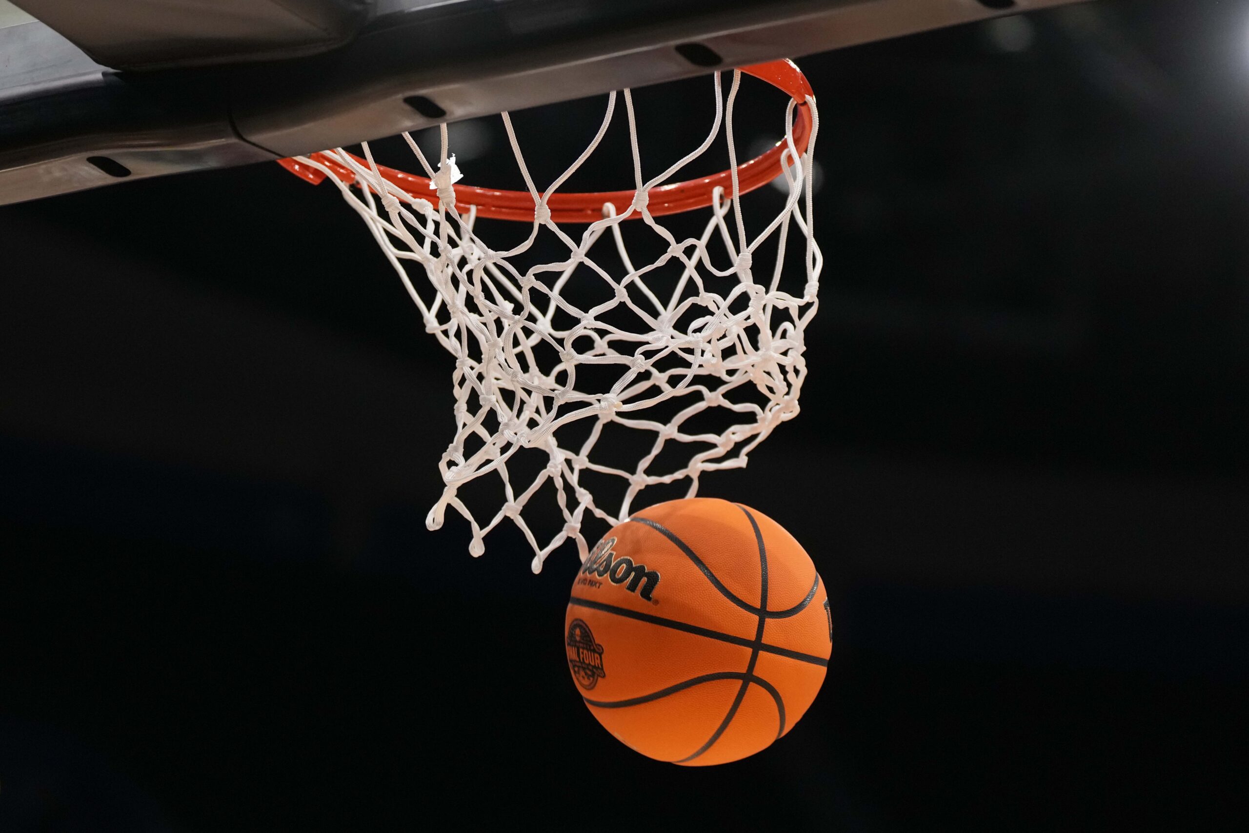Apr 3, 2025; Tampa, FL, USA; A Wilson EVO Nxt basketball ball with the 2025 NCAA Women's Final Four logo approaches the rim and the net at Amalie Arena. Mandatory Credit: Kirby Lee-Imagn Images