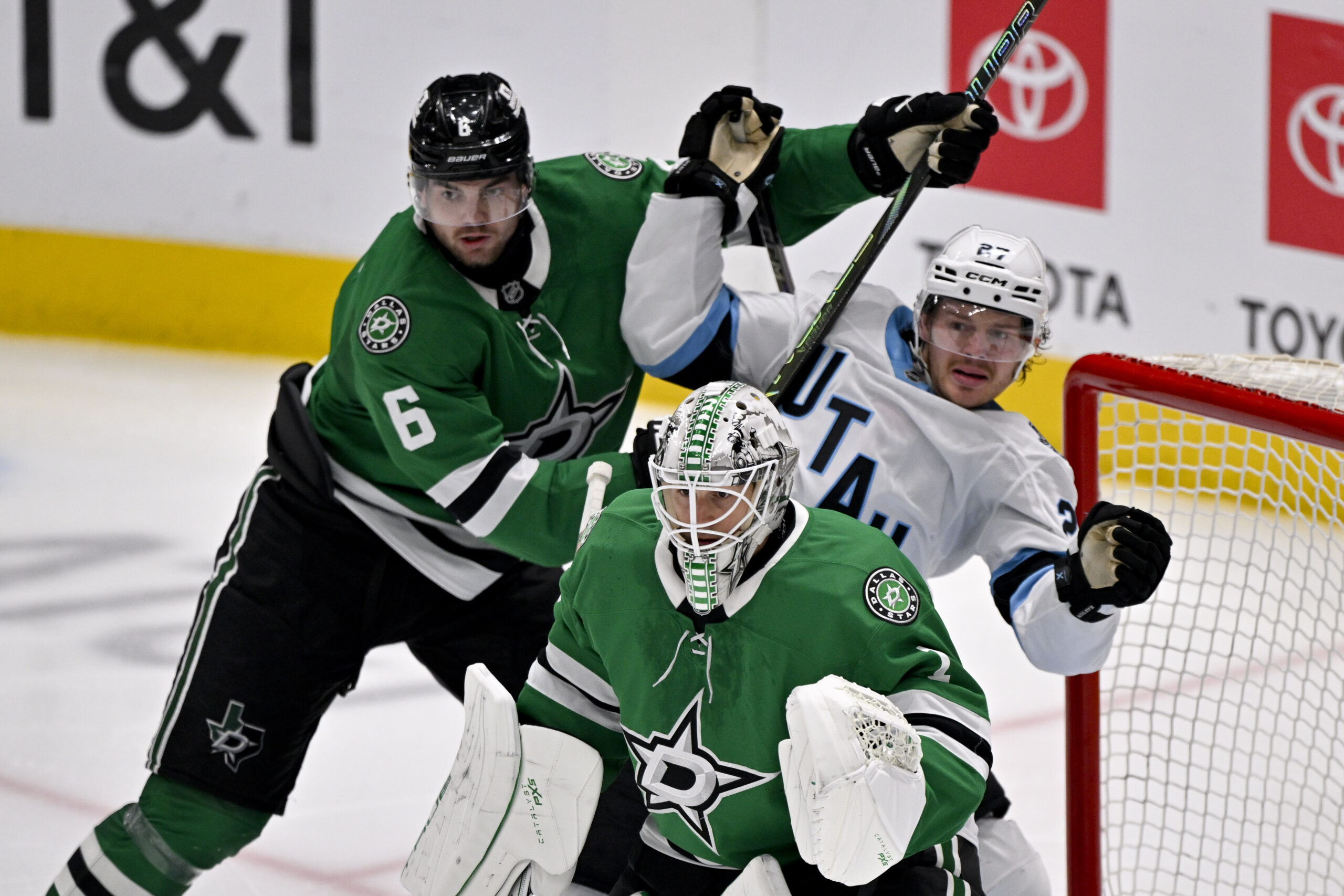 Apr 12, 2025; Dallas, Texas, USA; Dallas Stars defenseman Lian Bichsel (6) checks Utah Hockey Club center Barrett Hayton (27) behind goaltender Casey DeSmith (1) during the third period at the American Airlines Center. Mandatory Credit: Jerome Miron-Imagn Images