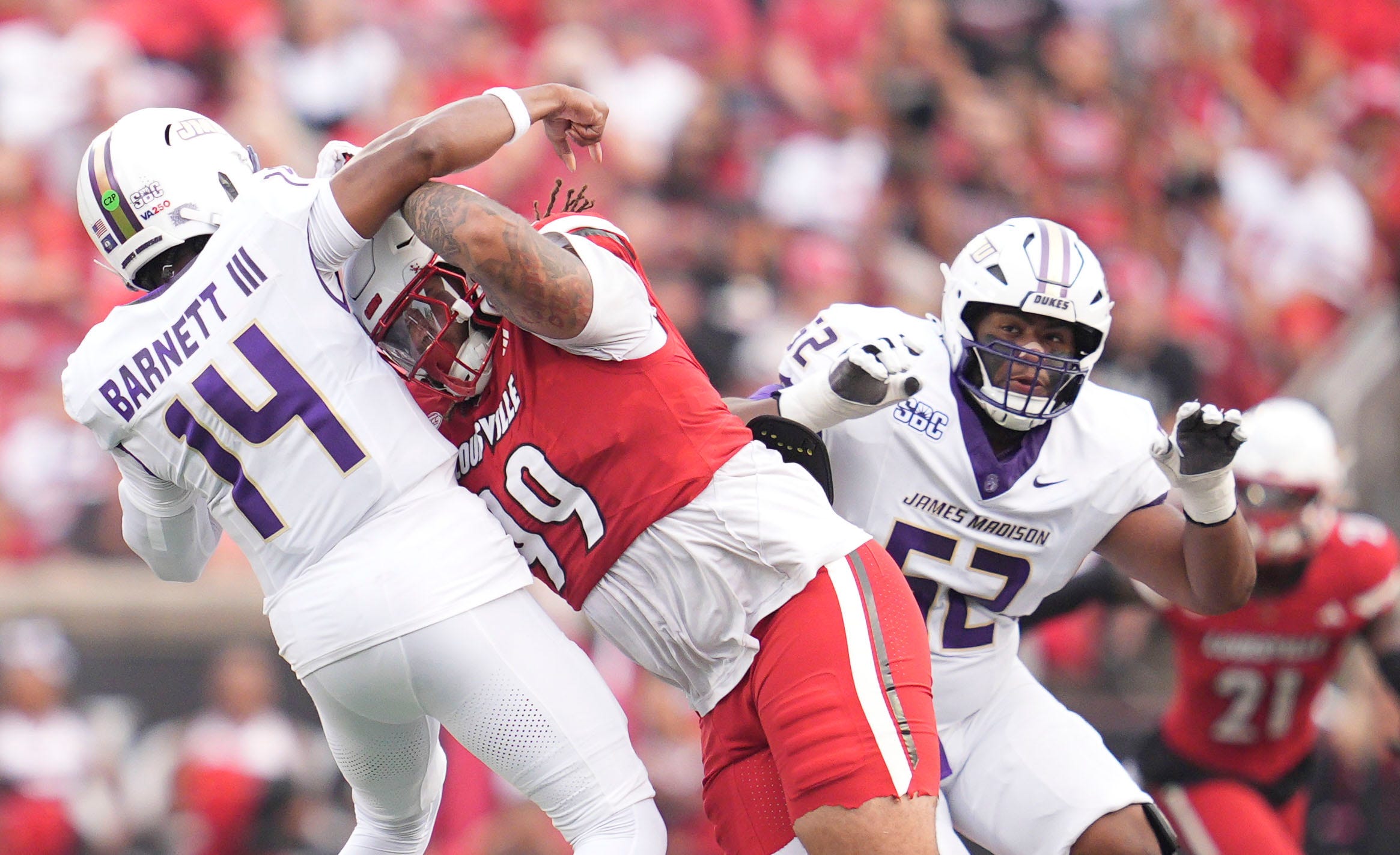 Louisville Cardinals defensive lineman Jordan Guerad (99) pressures James Madison Dukes quarterback Alonza Barnett III (14) in the first half Friday September 5, 2025 at L&N Federal Credit Union Stadium in Louisville, Kentucky.