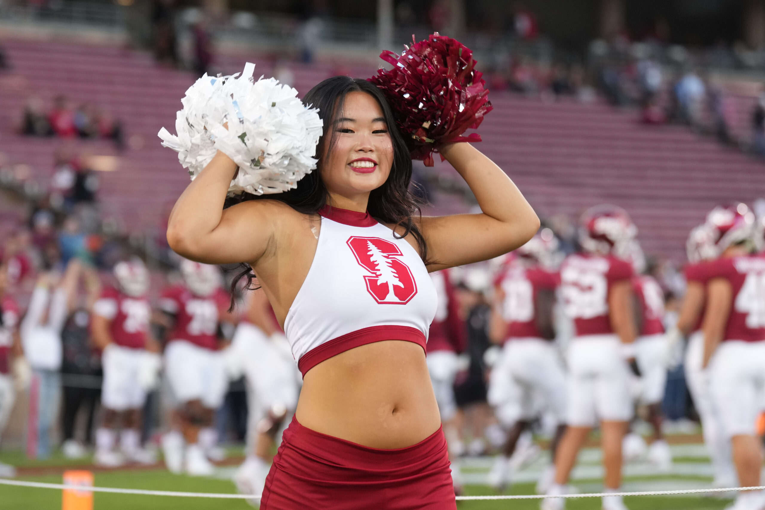 Sep 13, 2025; Stanford, California, USA; A Stanford Cardinal cheerleader performs on the field before the game against the Boston College Eagles at Stanford Stadium. Mandatory Credit: Darren Yamashita-Imagn Images
