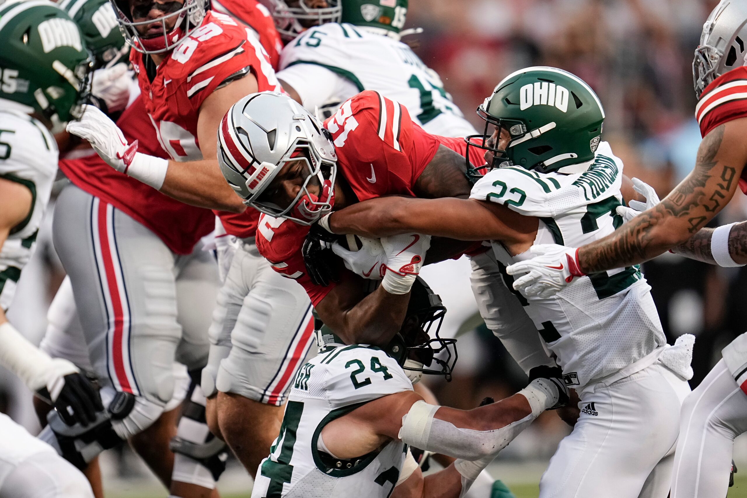 Ohio State Buckeyes running back CJ Donaldson (12) runs into Ohio Bobcats safety Jalen Thomeson (22) and linebacker Cameron Hollobaugh (24) during the NCAA football game at Ohio Stadium on Sept. 13, 2025. Ohio State won 37-9.