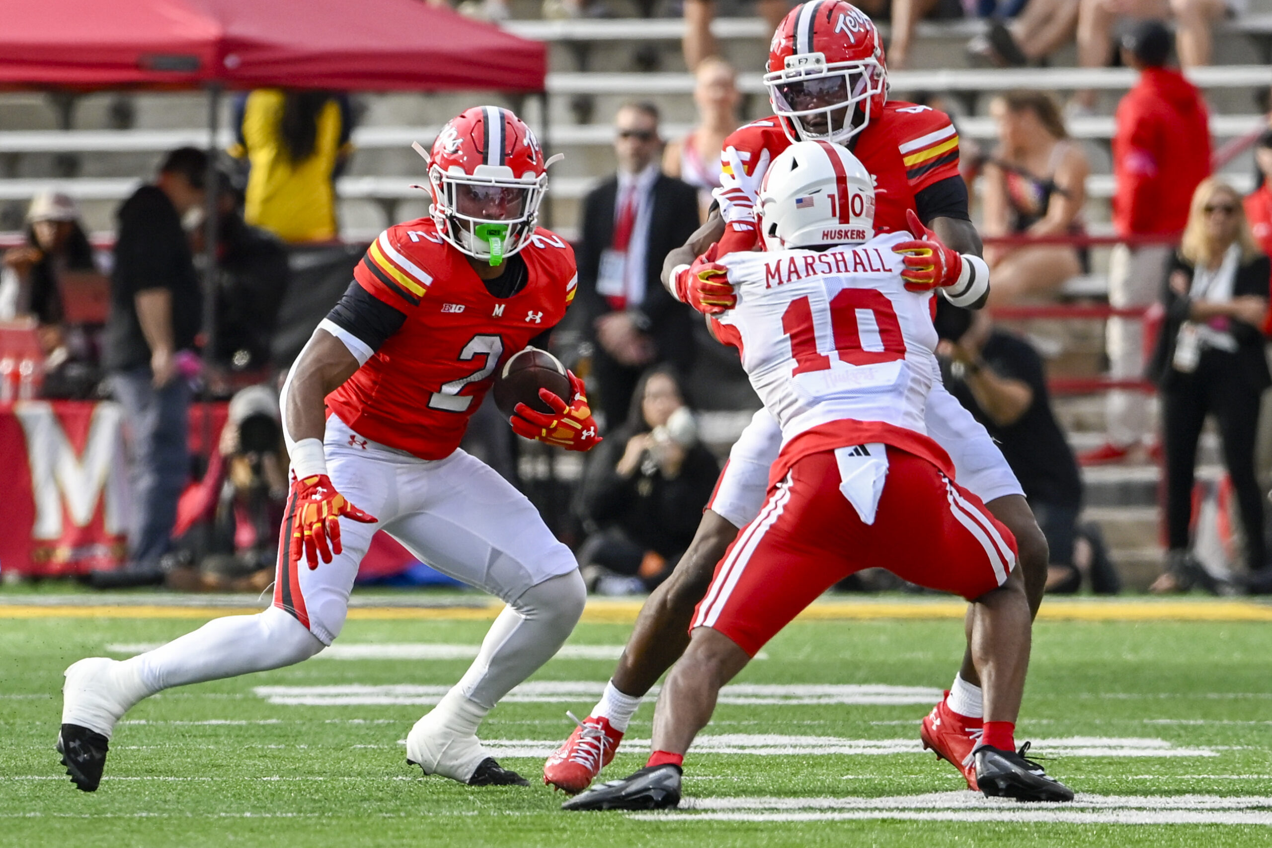 Oct 11, 2025; College Park, Maryland, USA;  Maryland Terrapins running back Nolan Ray (2) rushes as wide receiver Shaleak Knotts (4) blocks Nebraska Cornhuskers defensive back Andrew Marshall (10) during the first half at SECU Stadium. Mandatory Credit: Tommy Gilligan-Imagn Images