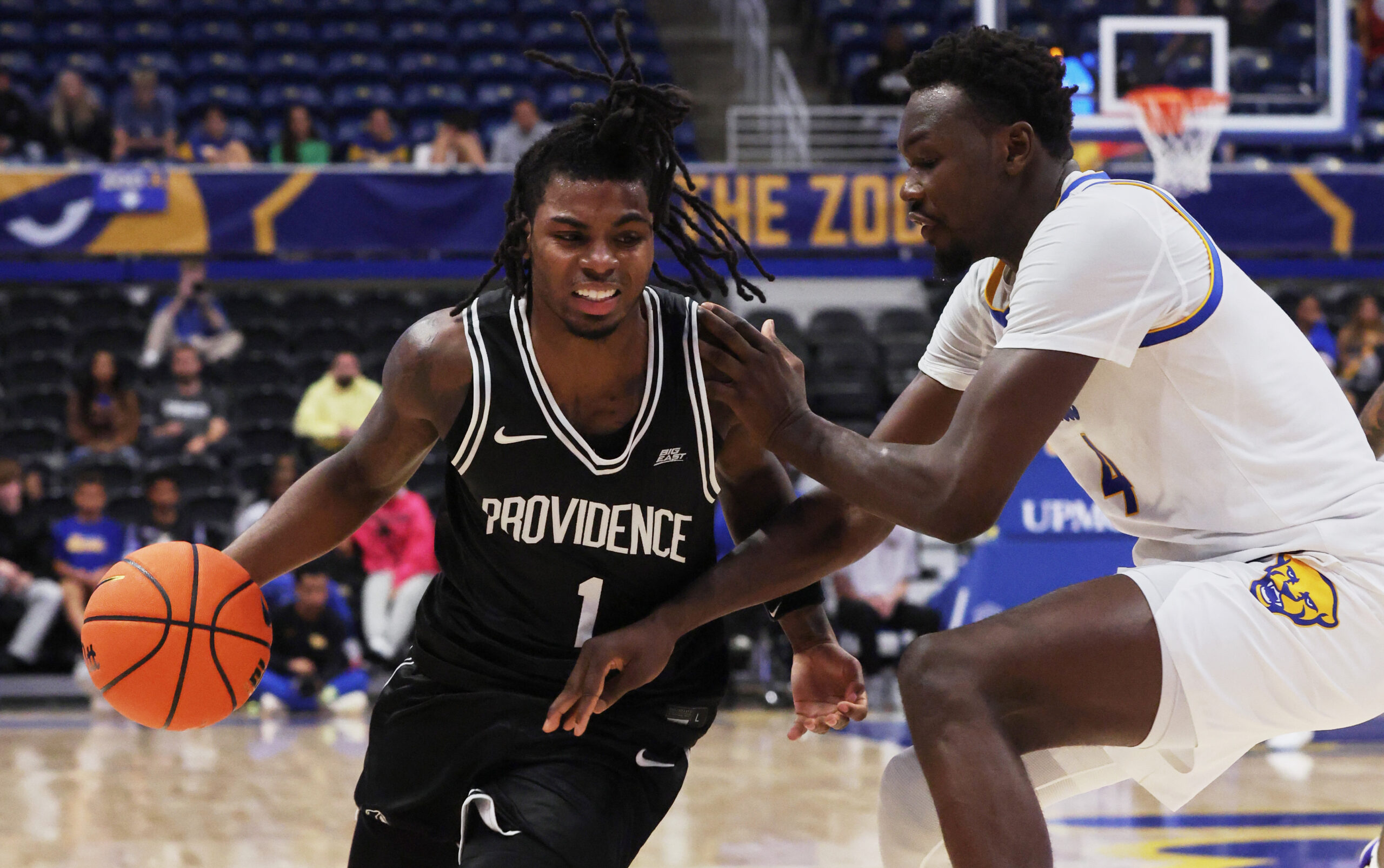 Oct 19, 2025; Pittsburgh, PA, USA;  Providence Friars guard Jason Edwards (1) drives to the basket against Pittsburgh Panthers forward Papa Amadou Kante (4)  during the second half at the Petersen Events Center. Mandatory Credit: Charles LeClaire-Imagn Images
