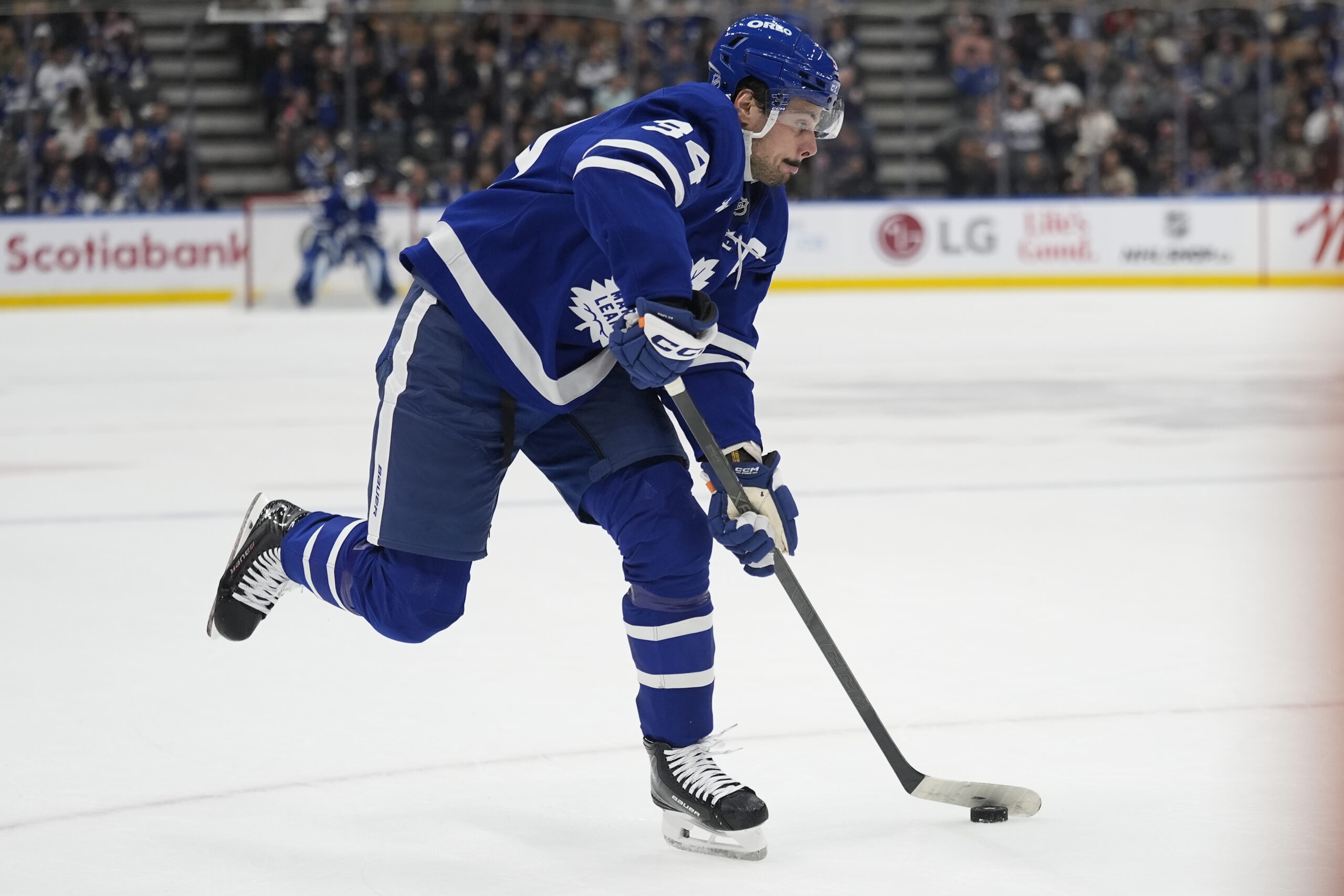 Oct 21, 2025; Toronto, Ontario, CAN; Toronto Maple Leafs forward Auston Matthews (34) shoots against the New Jersey Devils during the first period at Scotiabank Arena. Mandatory Credit: John E. Sokolowski-Imagn Images