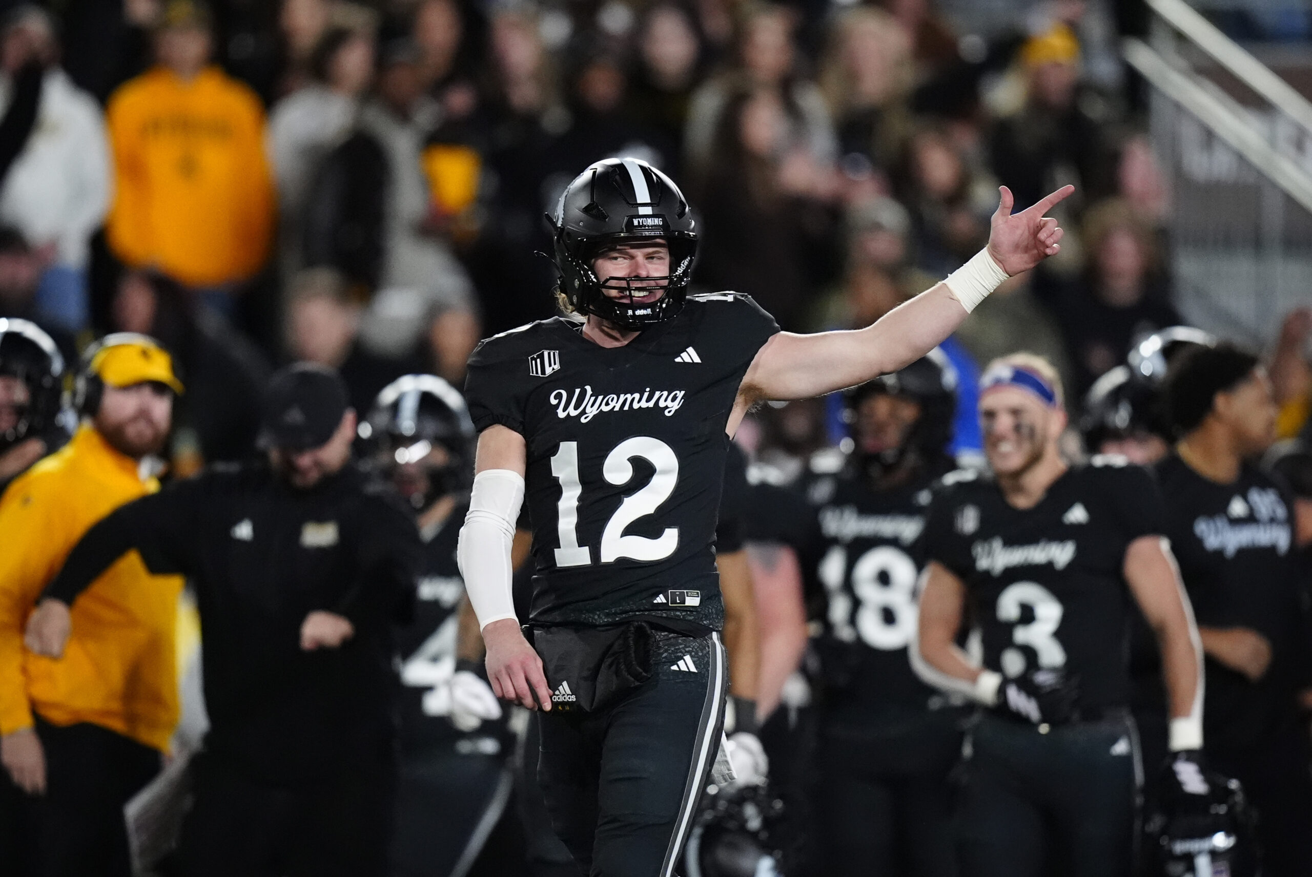 Oct 25, 2025; Laramie, Wyoming, USA; Wyoming Cowboys quarterback Kaden Anderson (12) celebrates a turnover on downs by the Colorado State Rams during the fourth quarter at Jonah Field at War Memorial Stadium. Mandatory Credit: Ron Chenoy-Imagn Images