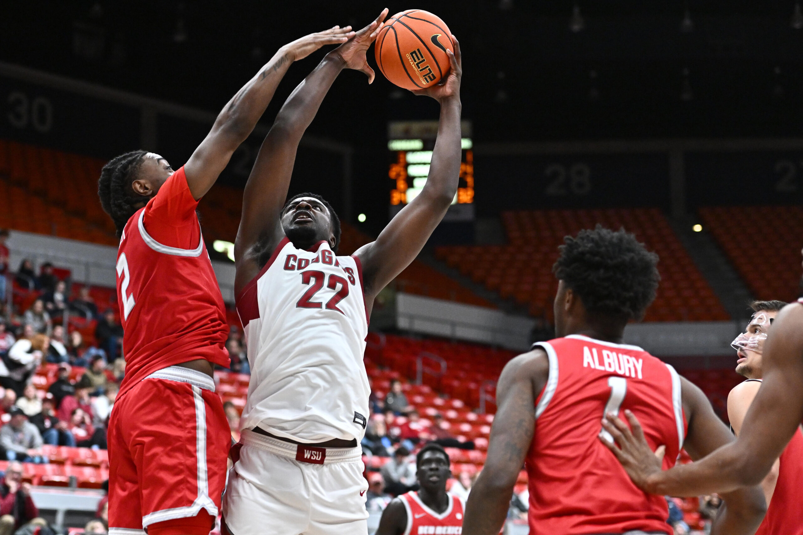 Oct 25, 2025; Pullman, WA, USA; Washington State Cougars forward Nd Okafor (22) is fouled on the shot by New Mexico Lobos guard Tajavis Miller (2) in the second half at Friel Court at Beasley Coliseum. Washington State Cougars won 74-66. Mandatory Credit: James Snook-Imagn Images