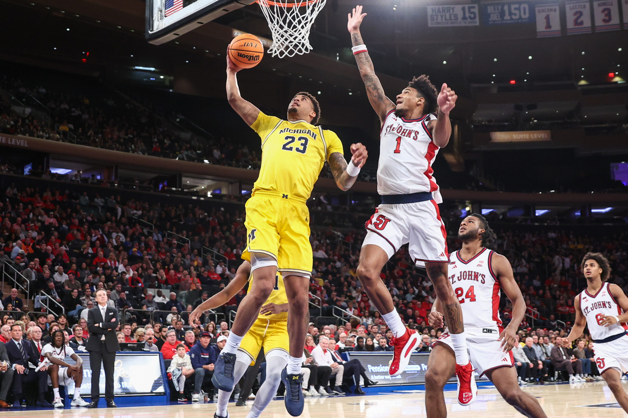 Oct 25, 2025; New York, NY, USA;  Michigan Wolverines forward Yaxel Lendeborg (23) and St. John's Red Storm forward Dillon Mitchell (1) at Madison Square Garden. Mandatory Credit: Wendell Cruz-Imagn Images