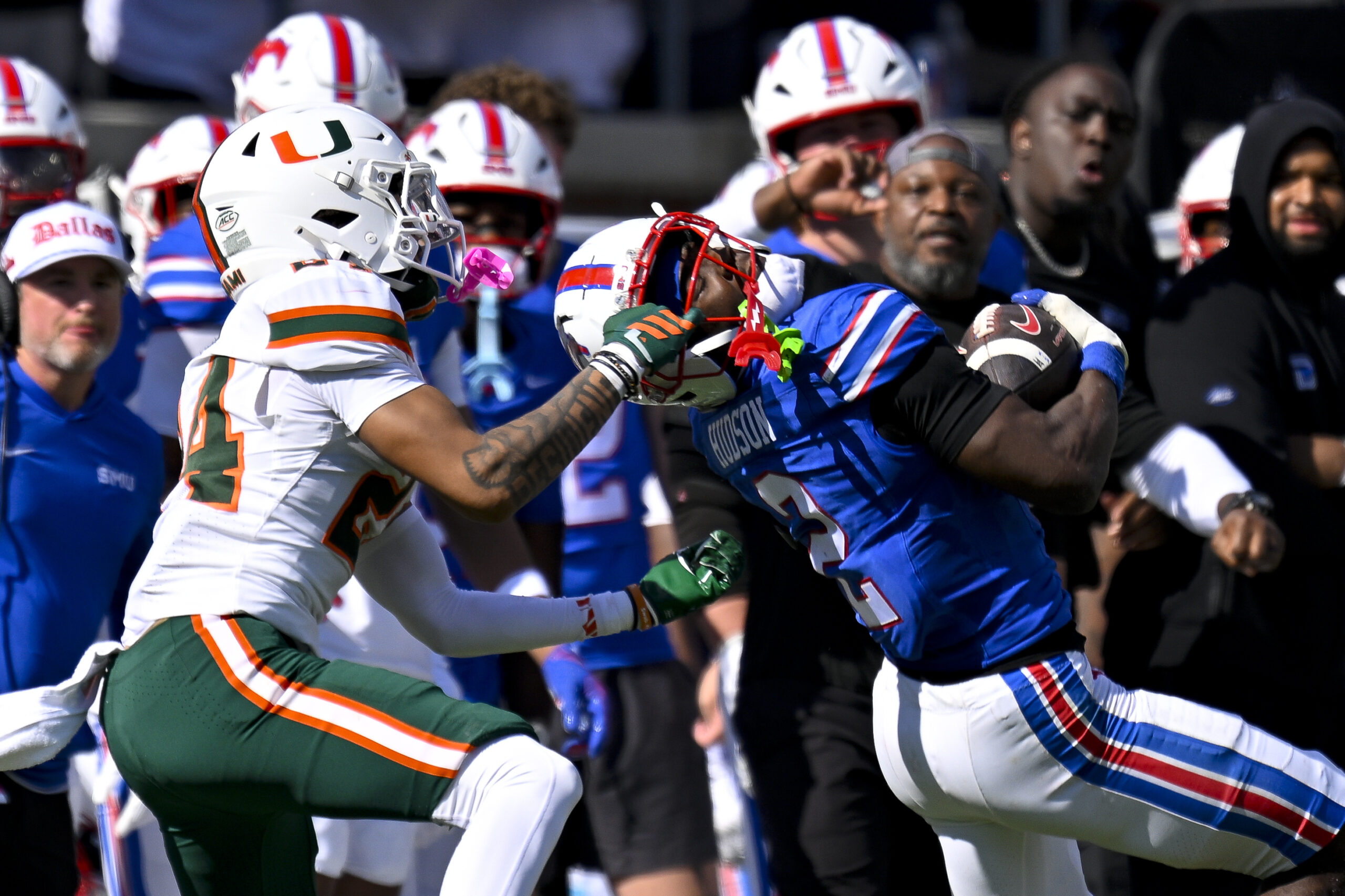 Nov 1, 2025; Dallas, Texas, USA;  SMU Mustangs wide receiver Jordan Hudson (2) catches a pass for a first down as he is tackled by Miami Hurricanes defensive back Ethan O'Connor (24) during the second half at Gerald J. Ford Stadium. Mandatory Credit: Jerome Miron-Imagn Images