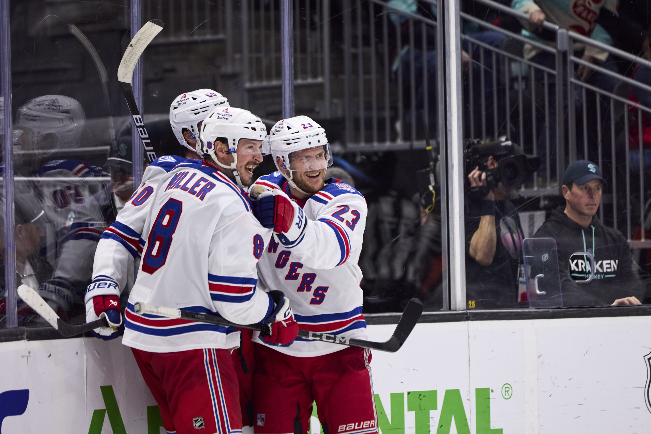 Nov 1, 2025; Seattle, Washington, USA;  New York Rangers left wing Will Cuylle (50), New York Rangers defenseman Adam Fox (23), and New York Rangers center J.T. Miller (8) celebrate an overtime win against the Seattle Kraken at Climate Pledge Arena. Mandatory Credit: Blake Dahlin-Imagn Images