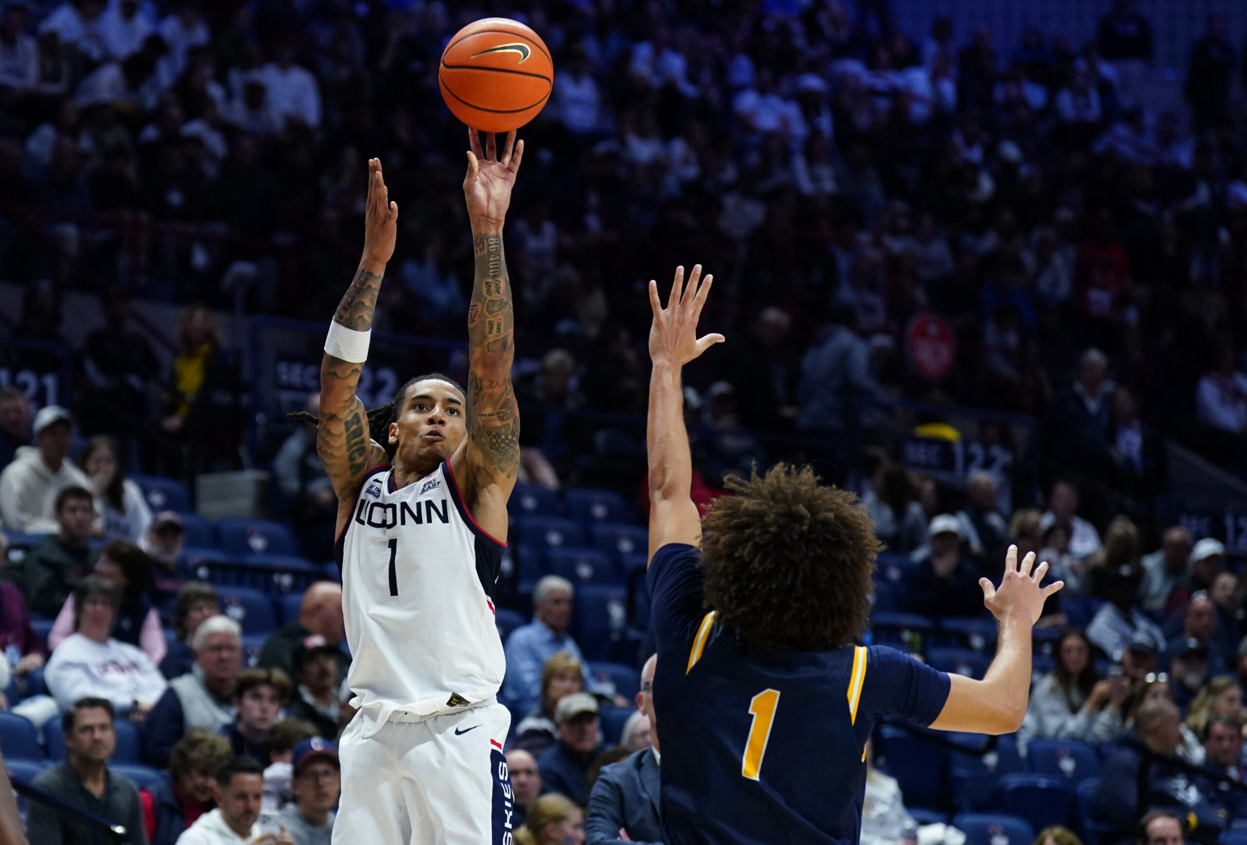 Nov 3, 2025; Storrs, Connecticut, USA; UConn Huskies guard Solo Ball (1) shoots against New Haven Chargers guard Jabri Fitzpatrick (1) in the second half at Harry A. Gampel Pavilion. Mandatory Credit: David Butler II-Imagn Images
