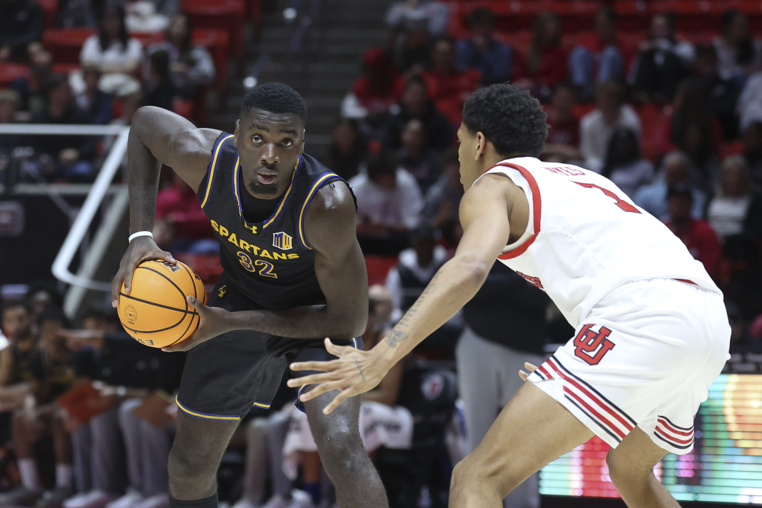 Nov 3, 2025; Salt Lake City, Utah, USA; San Jose State Spartans forward Yaphet Moundi (32) looks for a play against Utah Utes forward Josh Hayes (7) during the first half at Jon M. Huntsman Center. Mandatory Credit: Rob Gray-Imagn Images