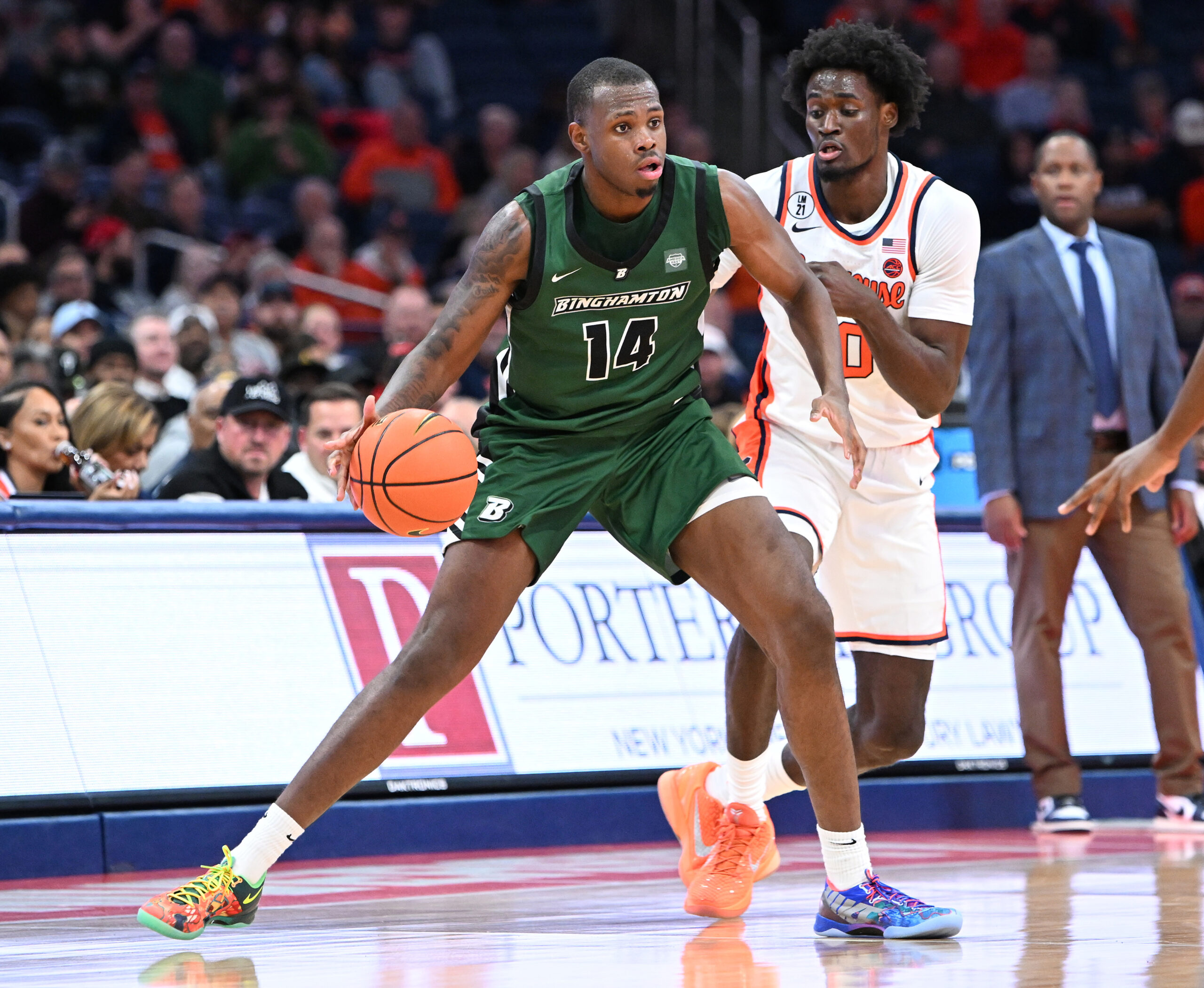 Nov 3, 2025; Syracuse, New York, USA; Binghamton Bearcats center Demetrius Lilley (14) handles the ball as Syracuse Orange forward Sadiq White Jr. (0) defends in the second half at the JMA Wireless Dome. Mandatory Credit: Mark Konezny-Imagn Images