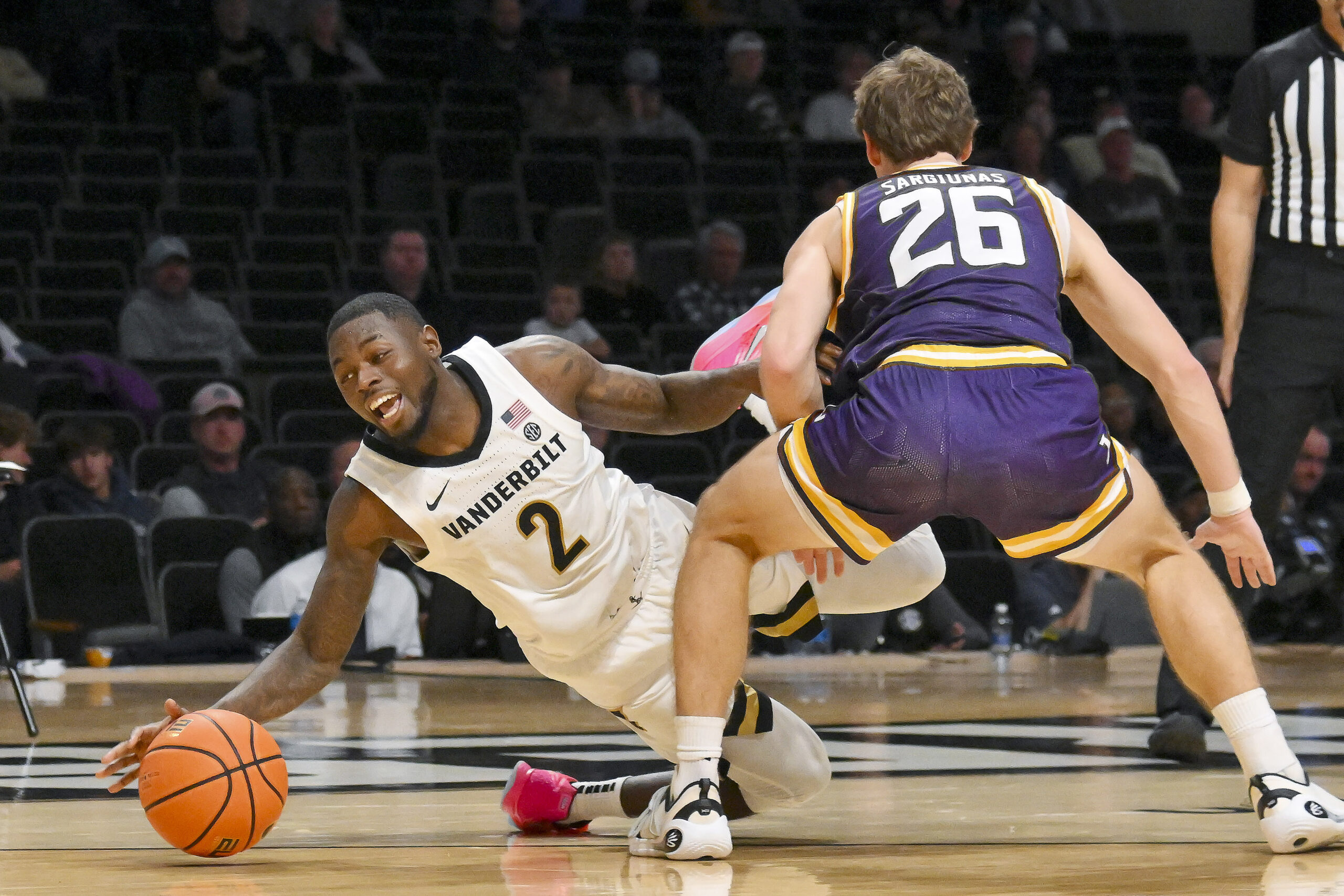 Nov 3, 2025; Nashville, Tennessee, USA;  Lipscomb Bisons forward Titas Sargiunas (26) fouls Vanderbilt Commodores guard Duke Miles (2) during the second half at Memorial Gymnasium. Mandatory Credit: Steve Roberts-Imagn Images