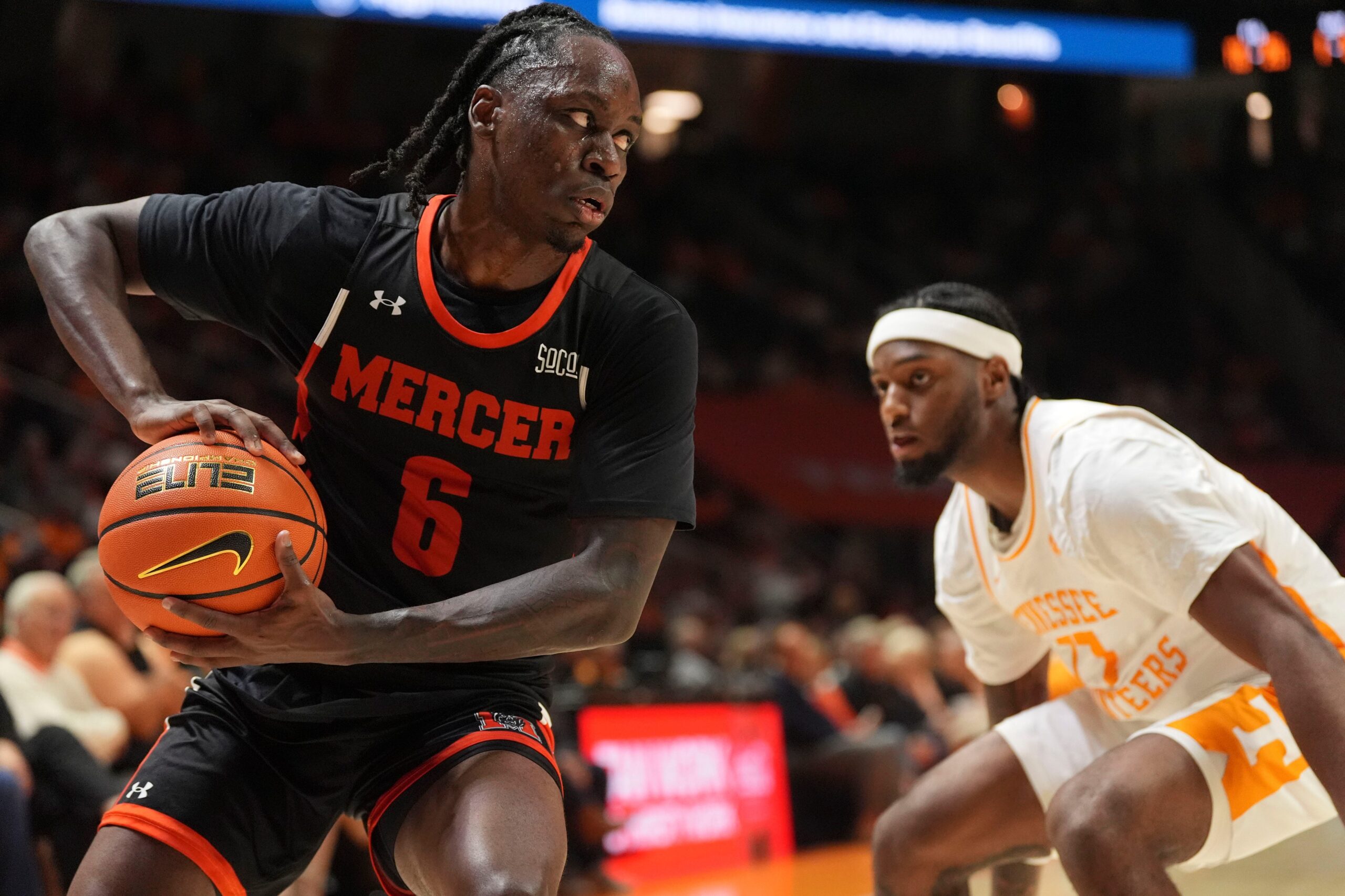 Mercer guard Baraka Okojie (6) moves the ball while guarded by Tennessee guard Amaree Abram (77) in an NCAA college basketball game on November 3, 2025, in Knoxville, Tenn.