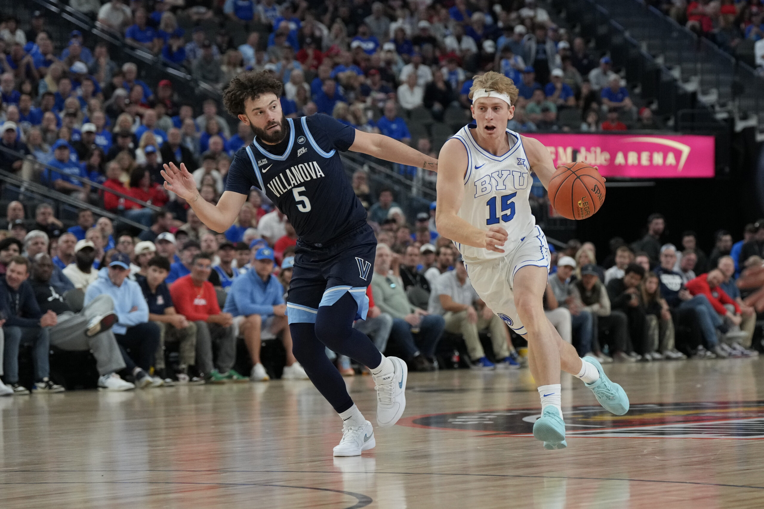Nov 3, 2025; Las Vegas, Nevada, USA; BYU Cougars guard Richie Saunders (15) dribbles the ball against Villanova Wildcats guard Devin Askew (5) during the first half of the Hall of Fame Series game at T-Mobile Arena. Mandatory Credit: Candice Ward-Imagn Images