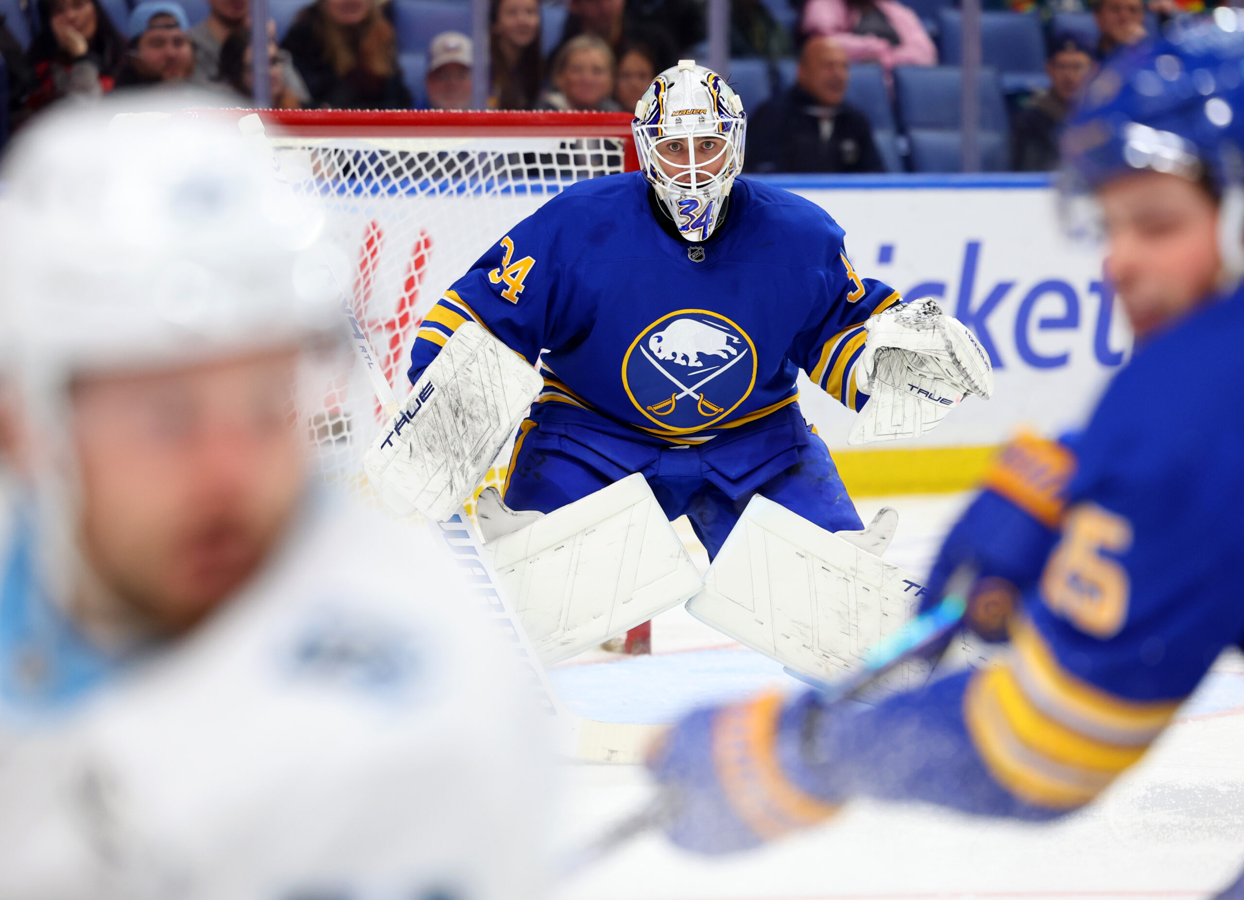 Nov 4, 2025; Buffalo, New York, USA; Buffalo Sabres goaltender Alex Lyon (34) looks for the puck during the third period against the Utah Mammoth at KeyBank Center. Mandatory Credit: Timothy T. Ludwig-Imagn Images