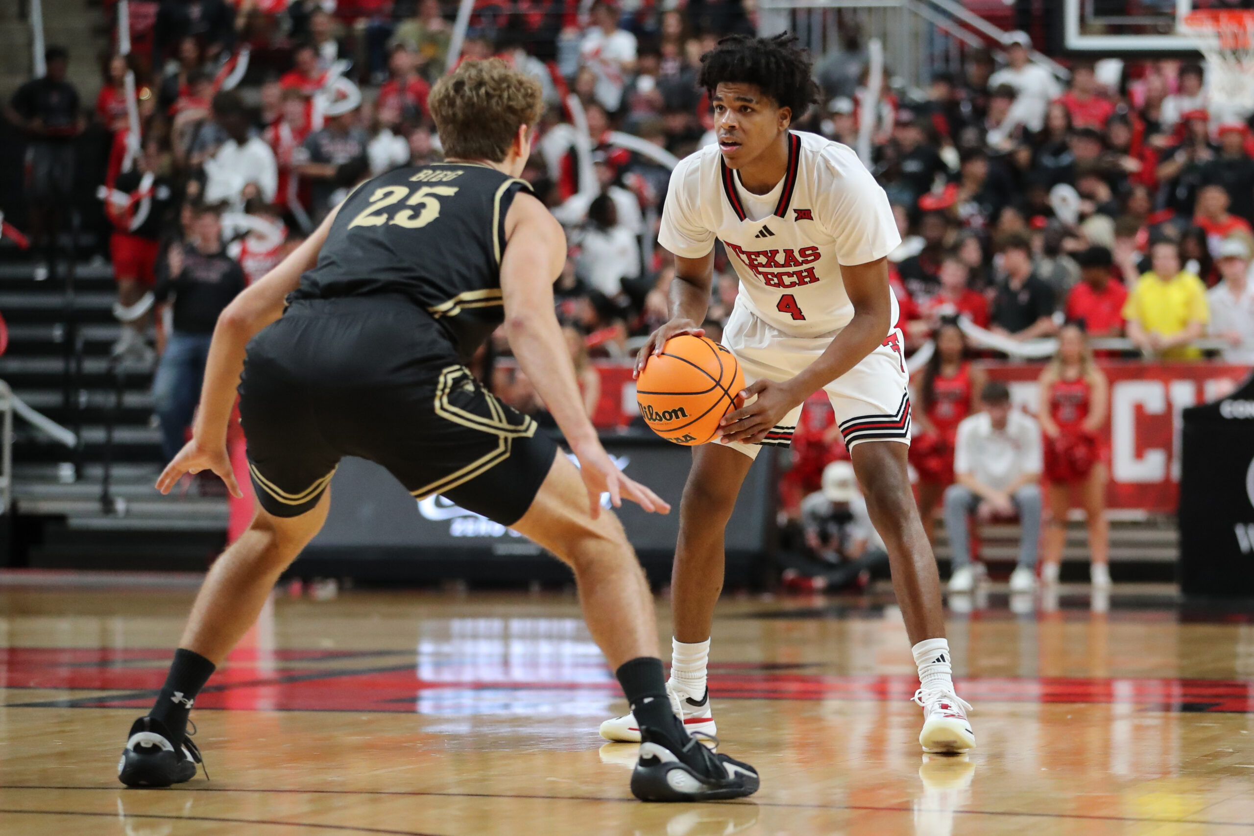 Nov 4, 2025; Lubbock, Texas, USA; Texas Tech Red Raiders guard Christian Anderson (4) dribbles the ball against Lindenwood Lions forward Todd Bieg (25) in the second half at United Supermarkets Arena. Mandatory Credit: Michael C. Johnson-Imagn Images