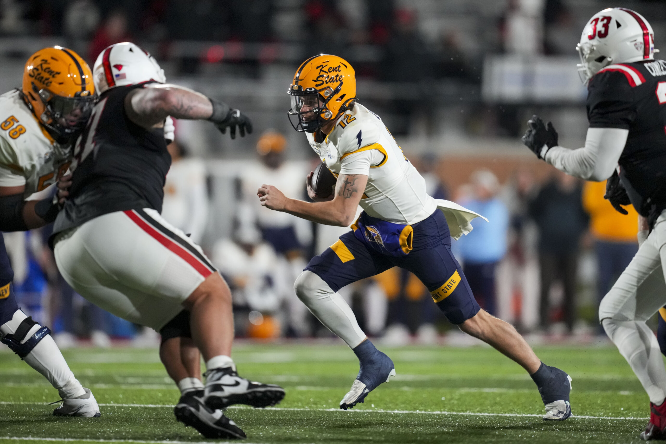 Nov 5, 2025; Muncie, Indiana, USA;  Kent State Golden Flashes quarterback Dru Deshields (12) runs with the ball against the Ball State Cardinals in the second half at Scheumann Stadium. Mandatory Credit: Aaron Doster-Imagn Images
