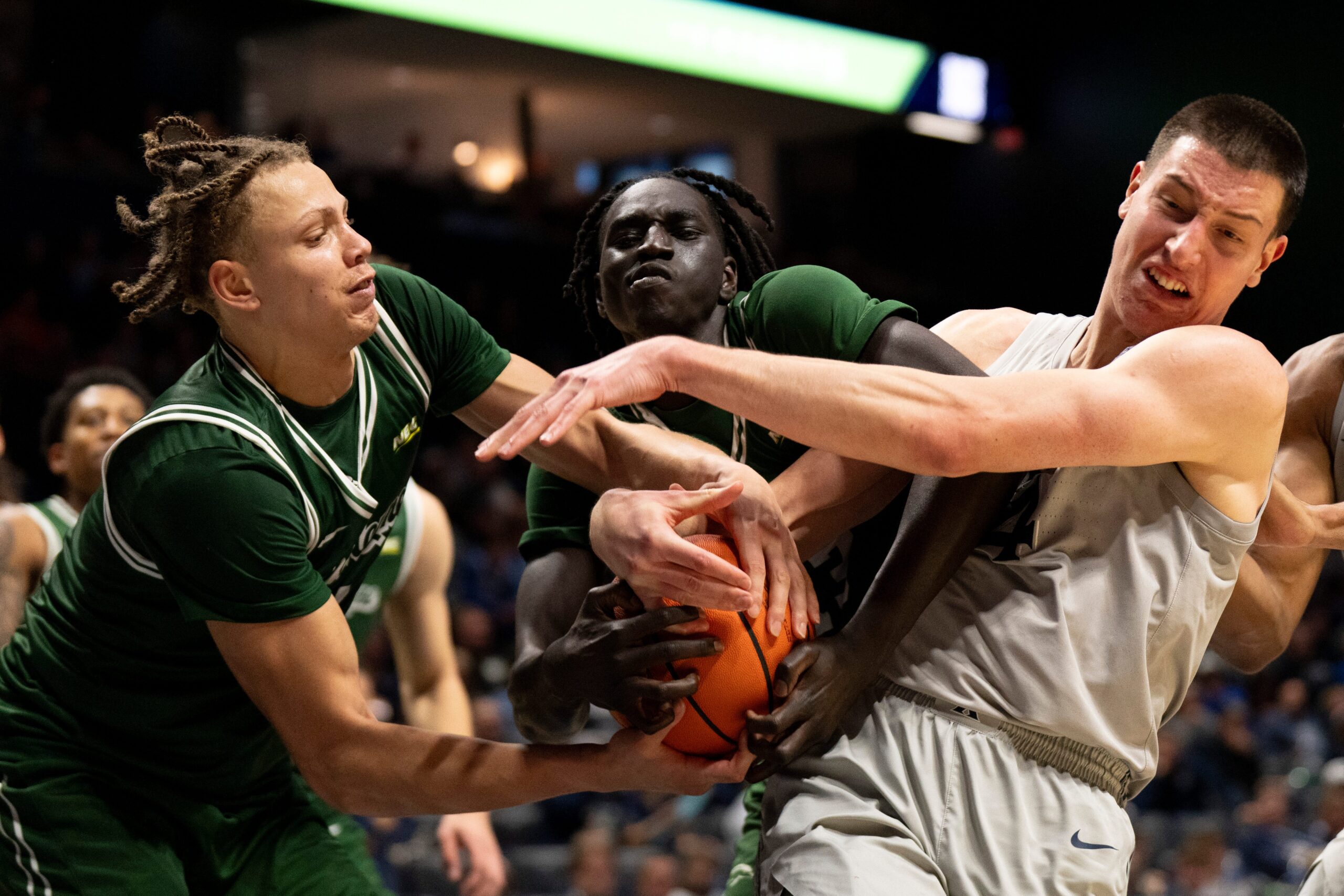 Xavier Musketeers forward Filip Borovicanin (4) fights for a rebound with Le Moyne Dolphins forward Shilo Jackson (4) and Le Moyne Dolphins guard Deng Garang (13) for a jump ball in the second half of the NCAA game at the Cintas Center in Cincinnati on Nov. 6, 2025.