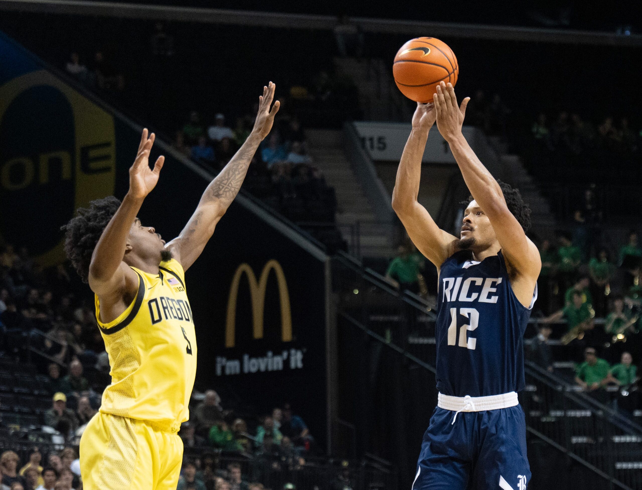 Rice’s Trae Broadnax, right, shoots over Oregon’s Takai Simpkins during the first half at Matthew Knight Arena in Eugene Nov. 7, 2025.