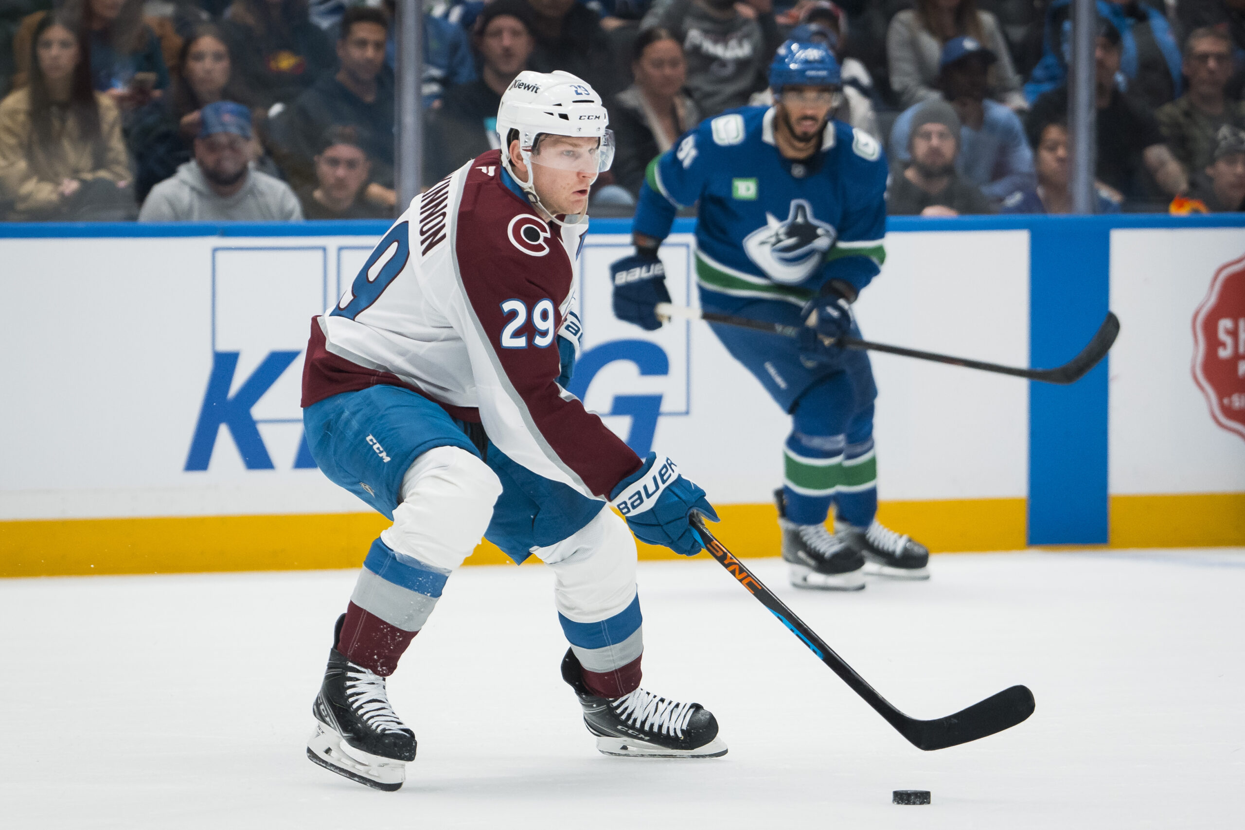 Nov 9, 2025; Vancouver, British Columbia, CAN; Colorado Avalanche forward Nathan MacKinnon (29) handles the puck against the Vancouver Canucks in the first period at Rogers Arena. Mandatory Credit: Bob Frid-Imagn Images