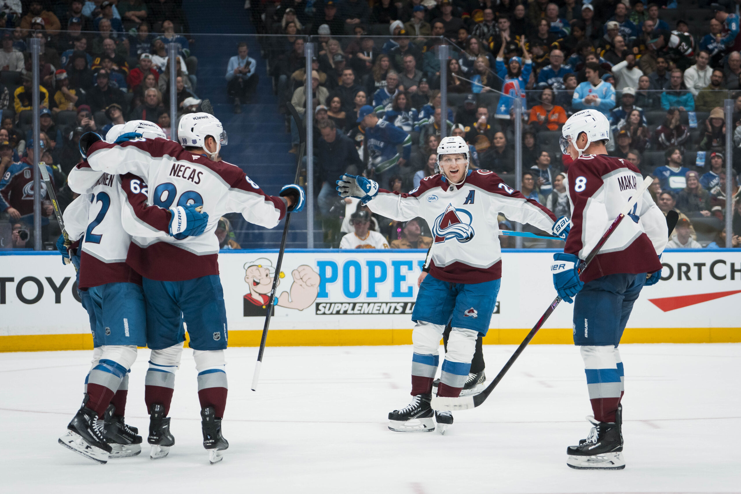 Nov 9, 2025; Vancouver, British Columbia, CAN; Colorado Avalanche forward Artturi Lehkonen (62) and forward Martin Necas (88) and forward Nathan MacKinnon (29) and defenseman Cale Makar (8) celebrate Lehkonen’s second gaol of the game against the Vancouver Canucks in the third period at Rogers Arena. Mandatory Credit: Bob Frid-Imagn Images