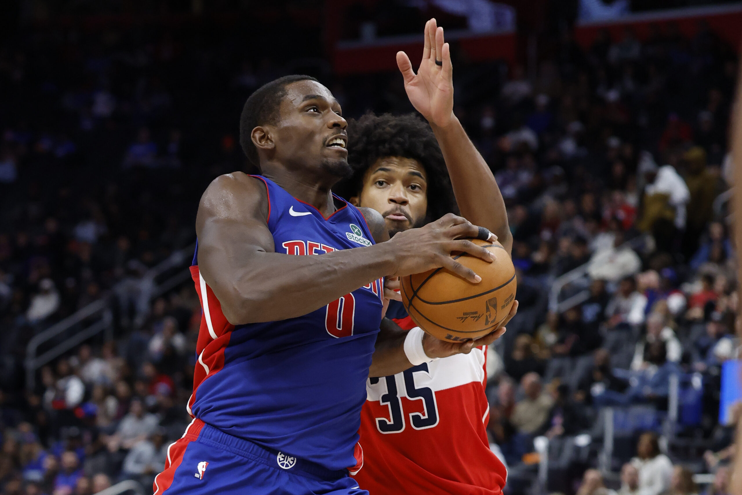 Nov 10, 2025; Detroit, Michigan, USA; Detroit Pistons center Jalen Duren (0) dribbles defended by Washington Wizards forward Marvin Bagley III (35) in the second half at Little Caesars Arena. Mandatory Credit: Rick Osentoski-Imagn Images